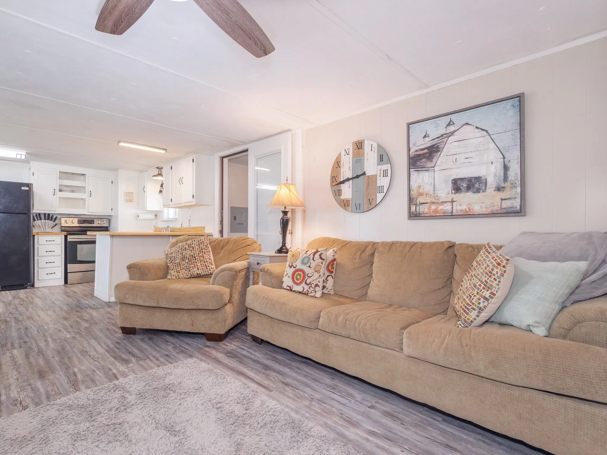 Living area featuring wood finished floors and ceiling fan