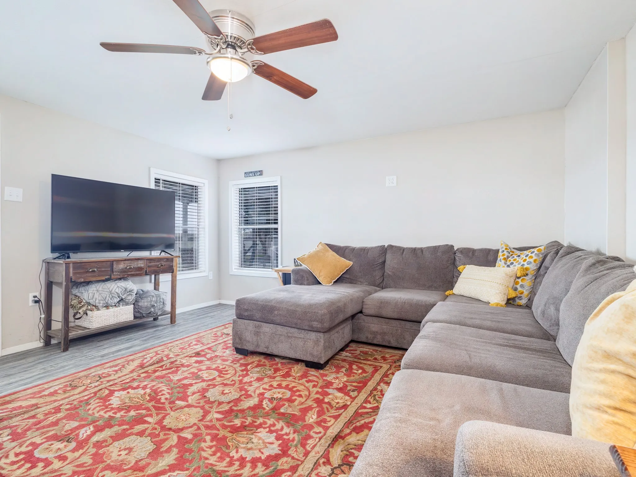 Living room with ceiling fan and wood finished floors