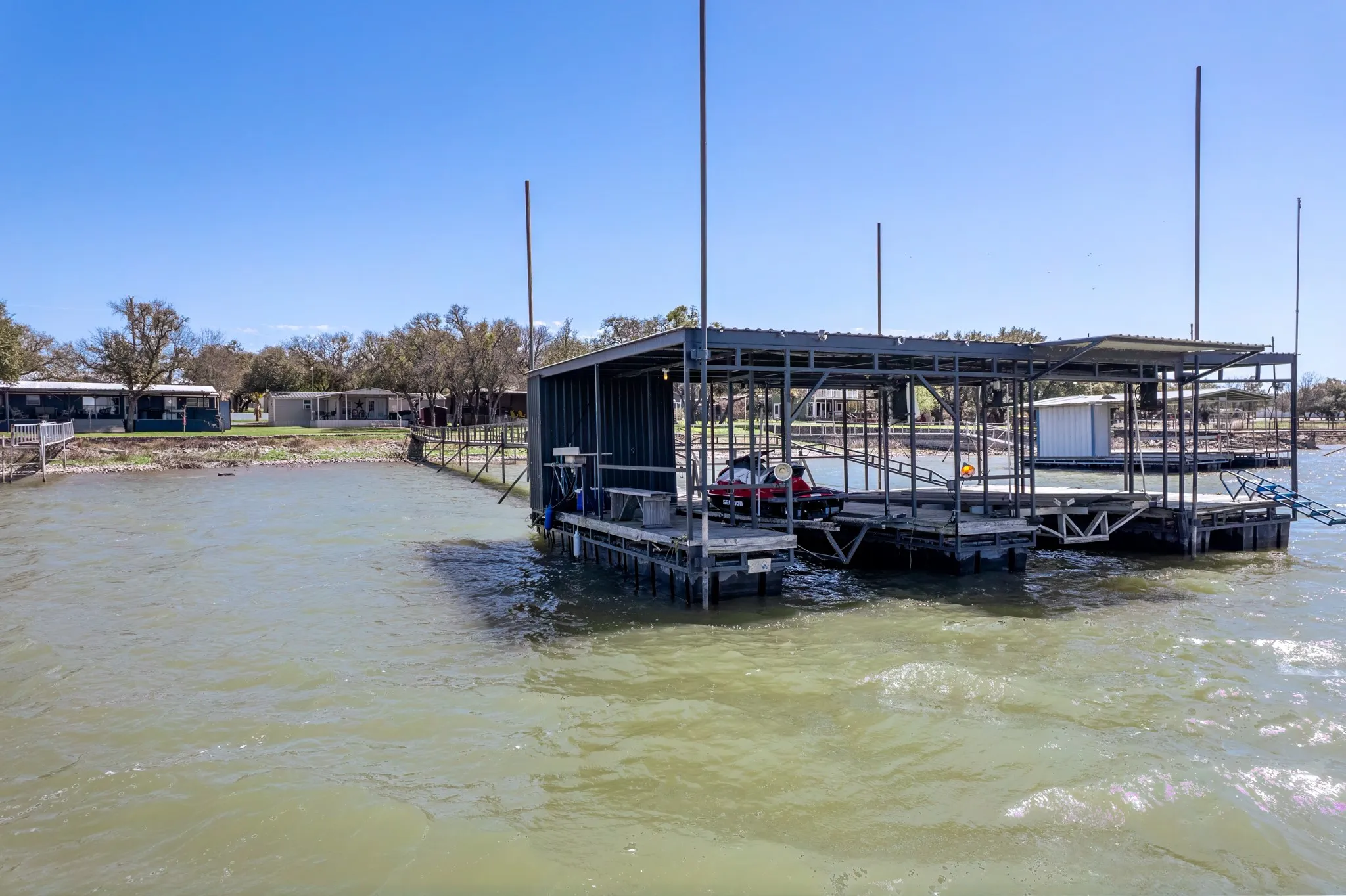 Dock area with a water view and boat lift