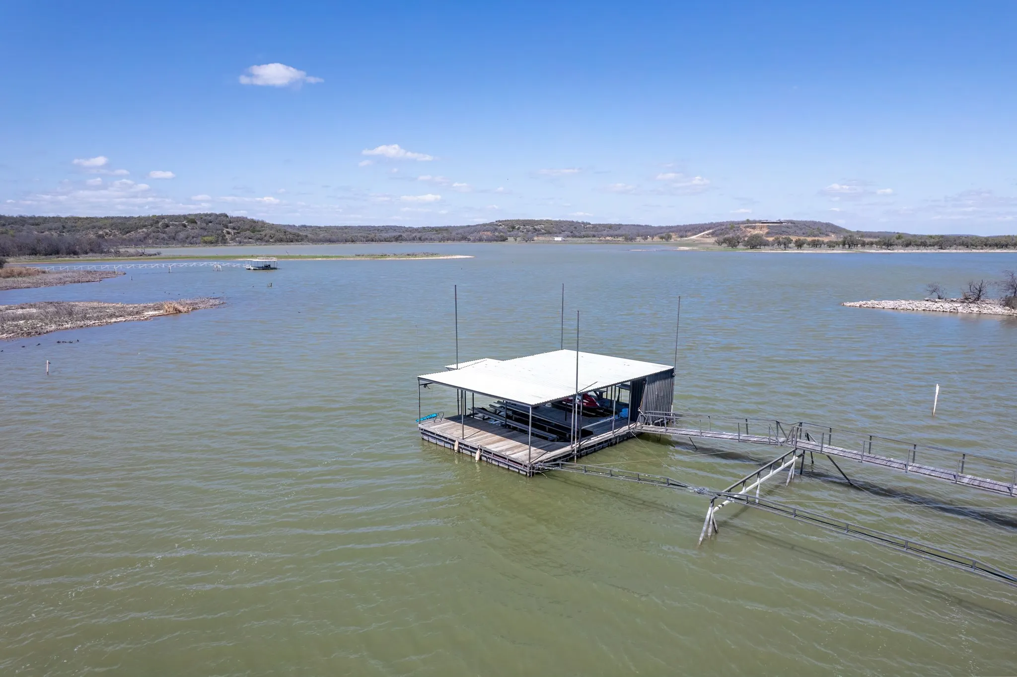 Dock area featuring a water view and boat lift