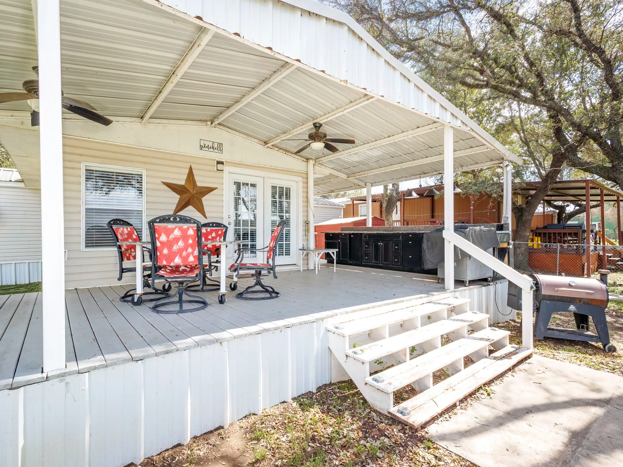 Deck with ceiling fan, a grill, and outdoor dining area