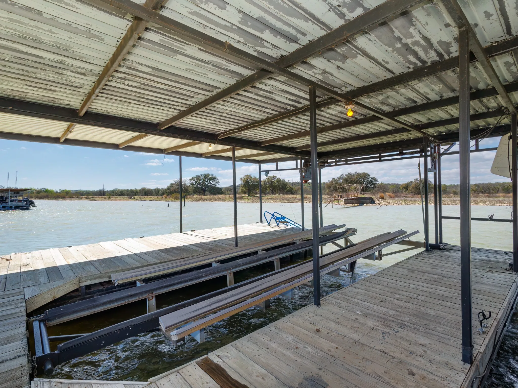 Dock featuring boat lift and a water view