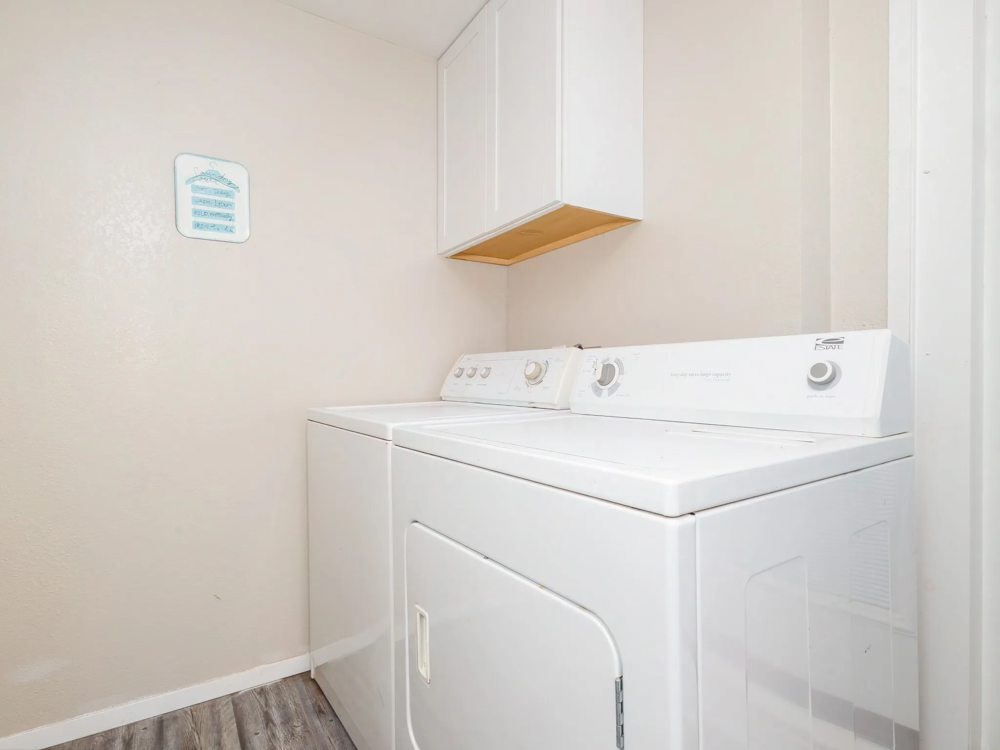 Laundry room featuring cabinet space, washer and dryer, and light wood-type flooring