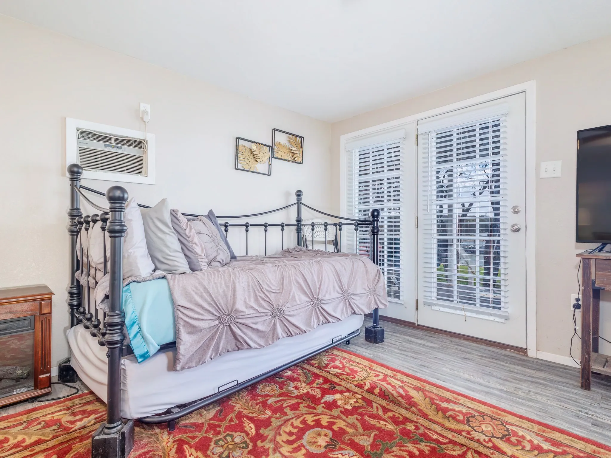 Bedroom with light wood-type flooring and access to outside