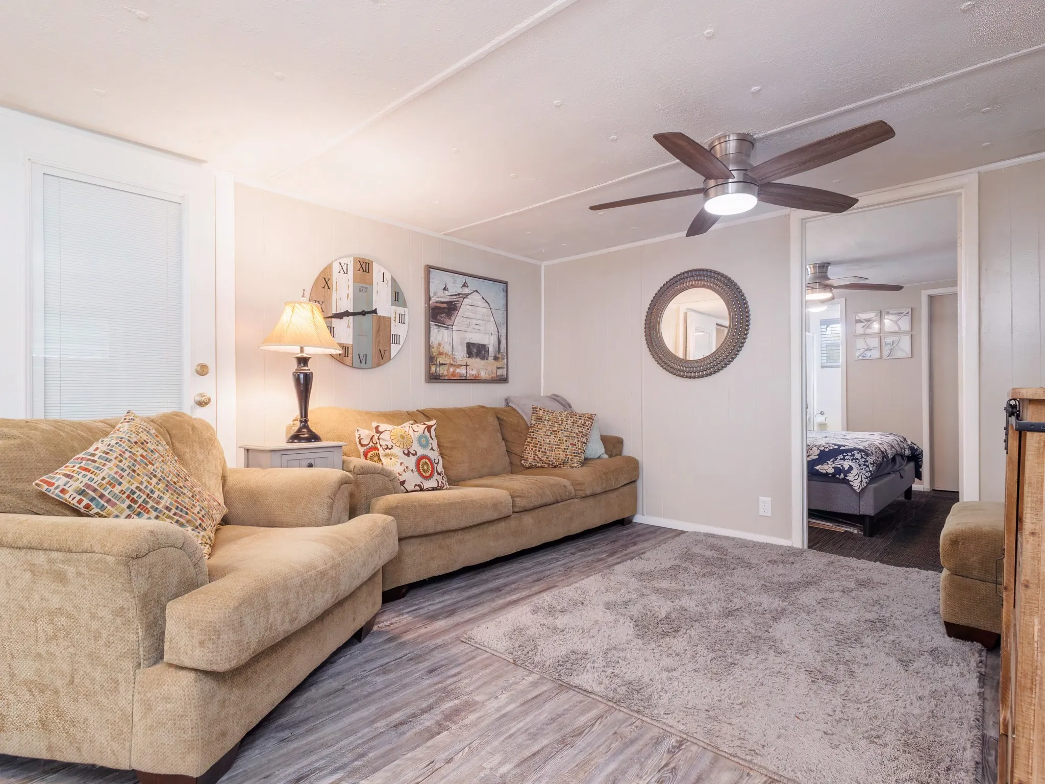 Living area with wood finished floors and a ceiling fan