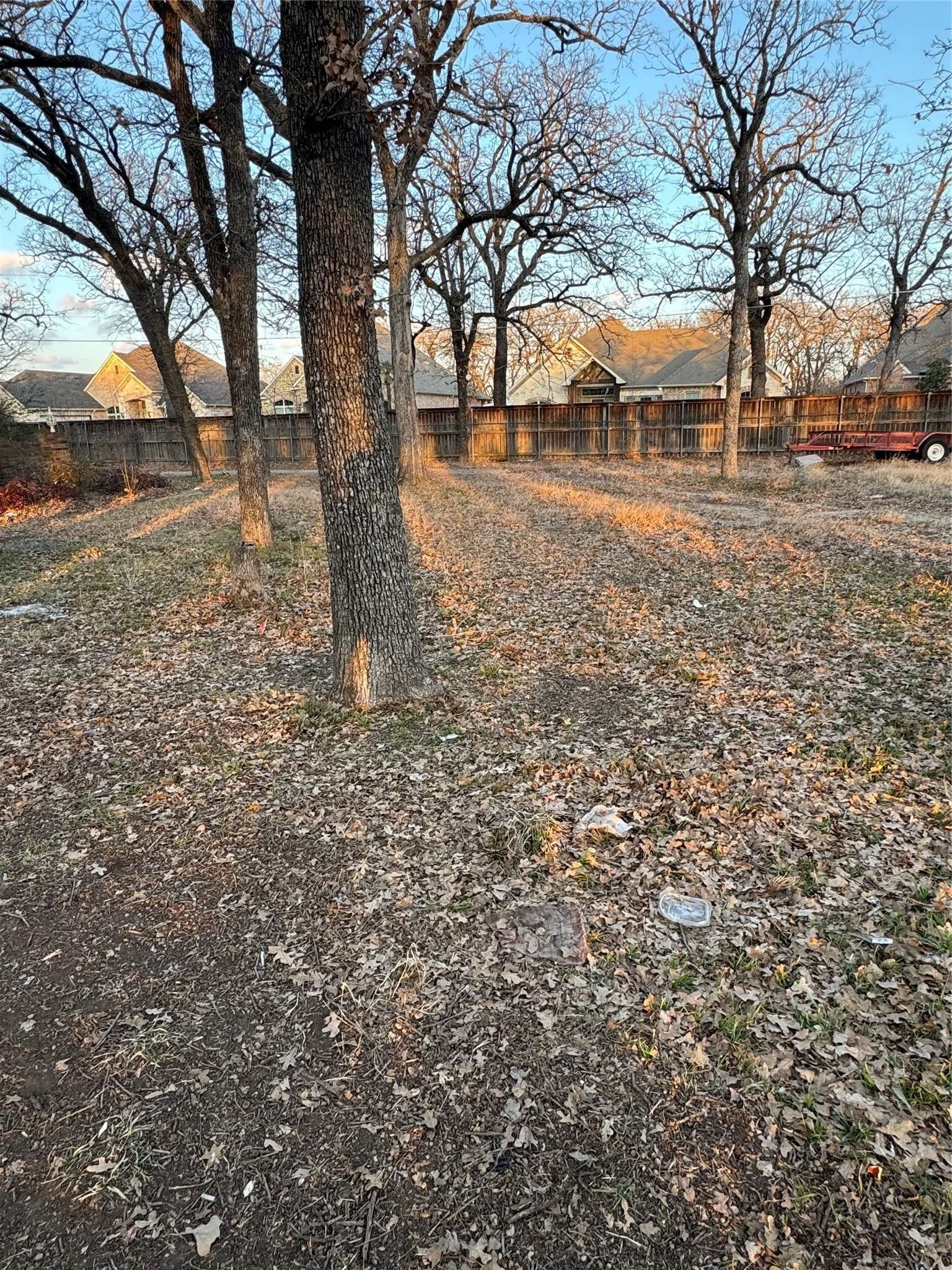 Fenced backyard featuring a residential view