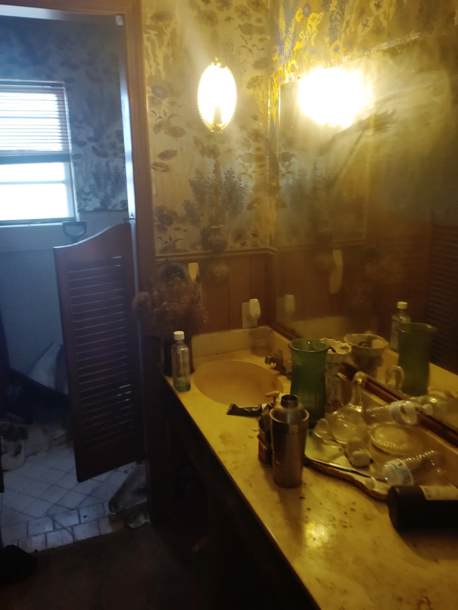 Bathroom featuring vanity and wallpapered walls