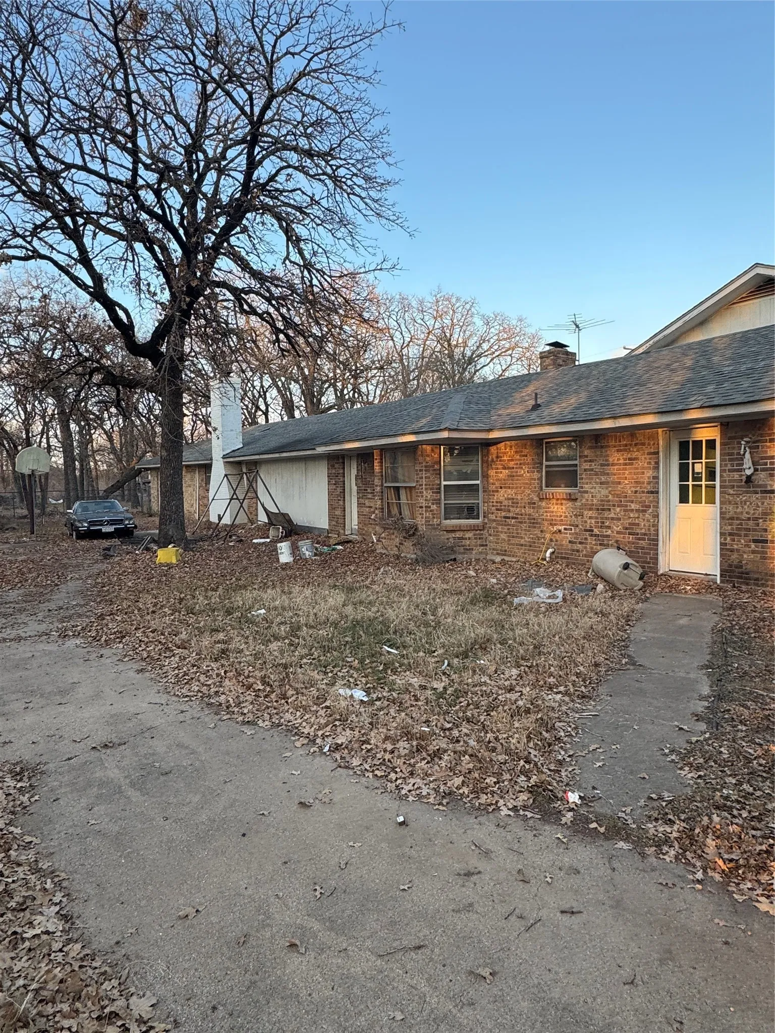 View of front of home with a chimney and brick siding