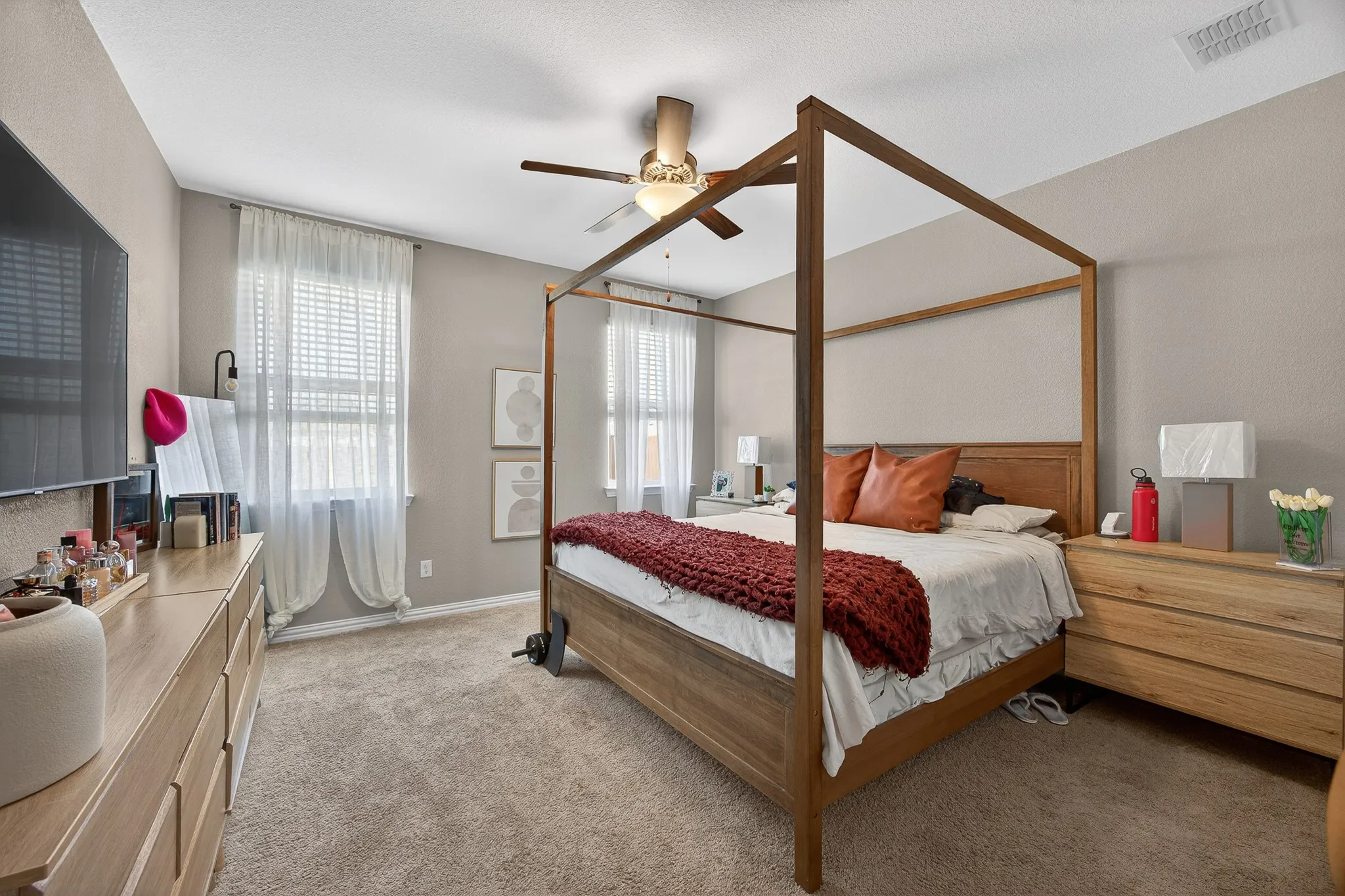 Bedroom featuring light colored carpet and ceiling fan