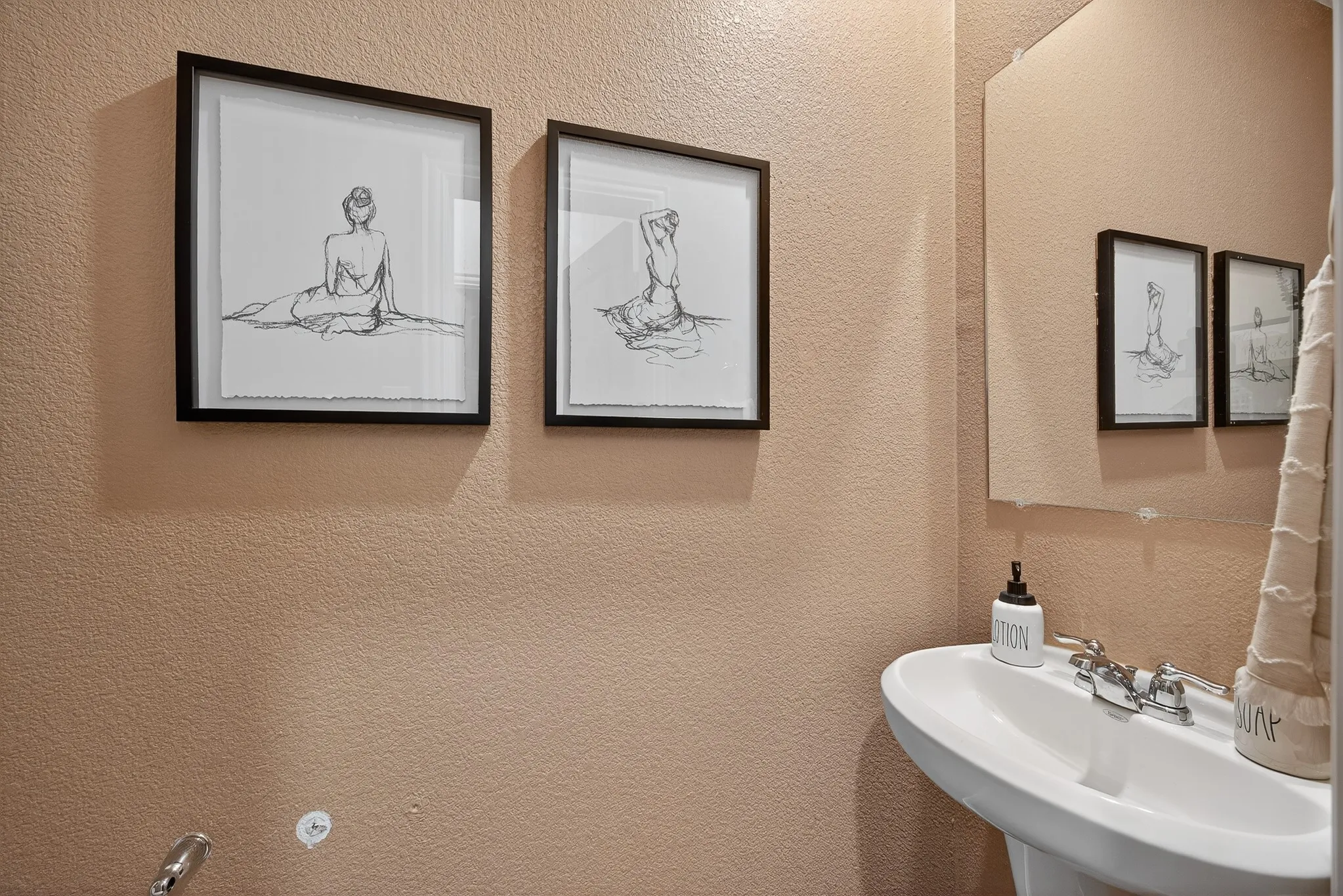 Bathroom featuring a sink and a textured wall
