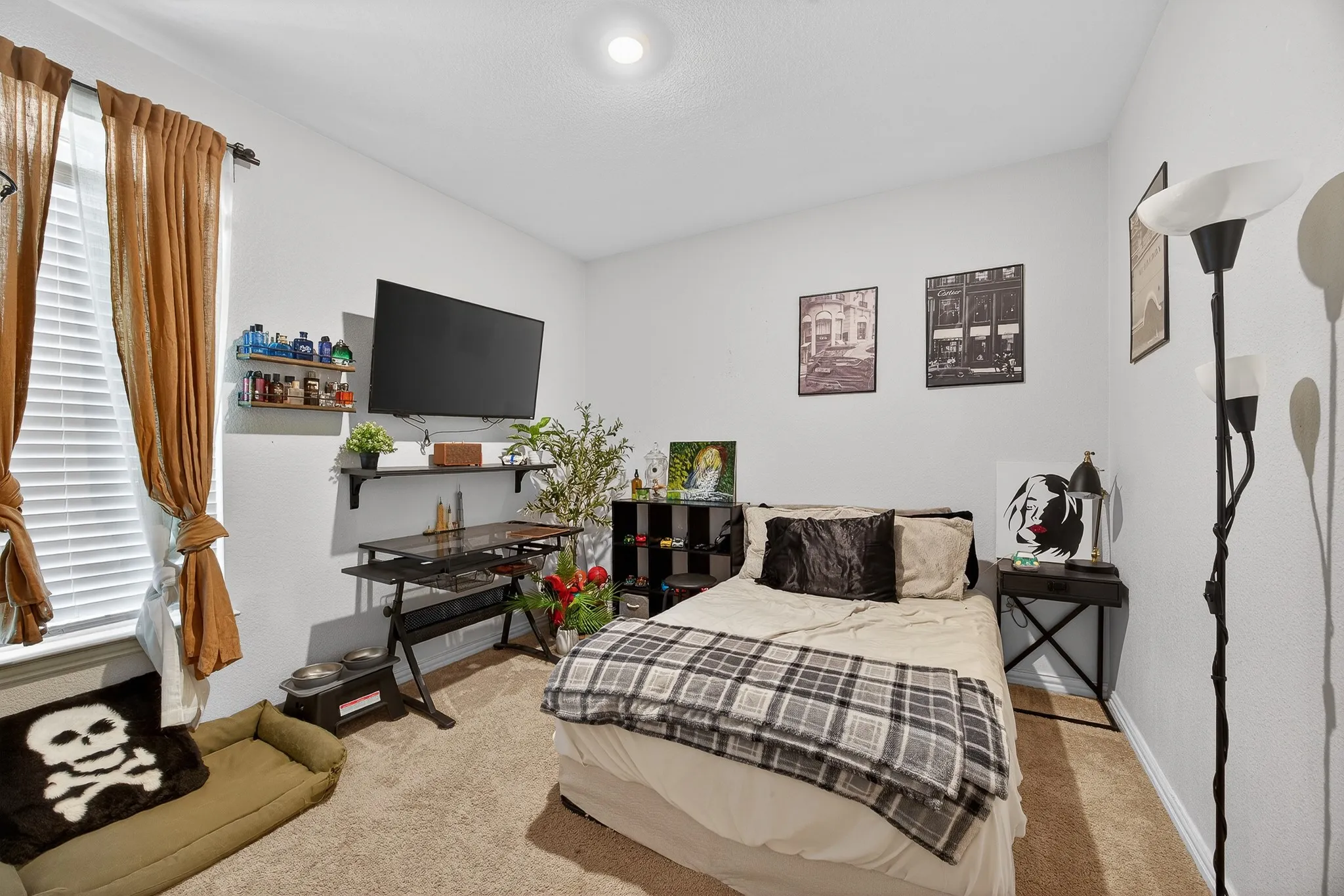 Bedroom with light colored carpet and baseboards