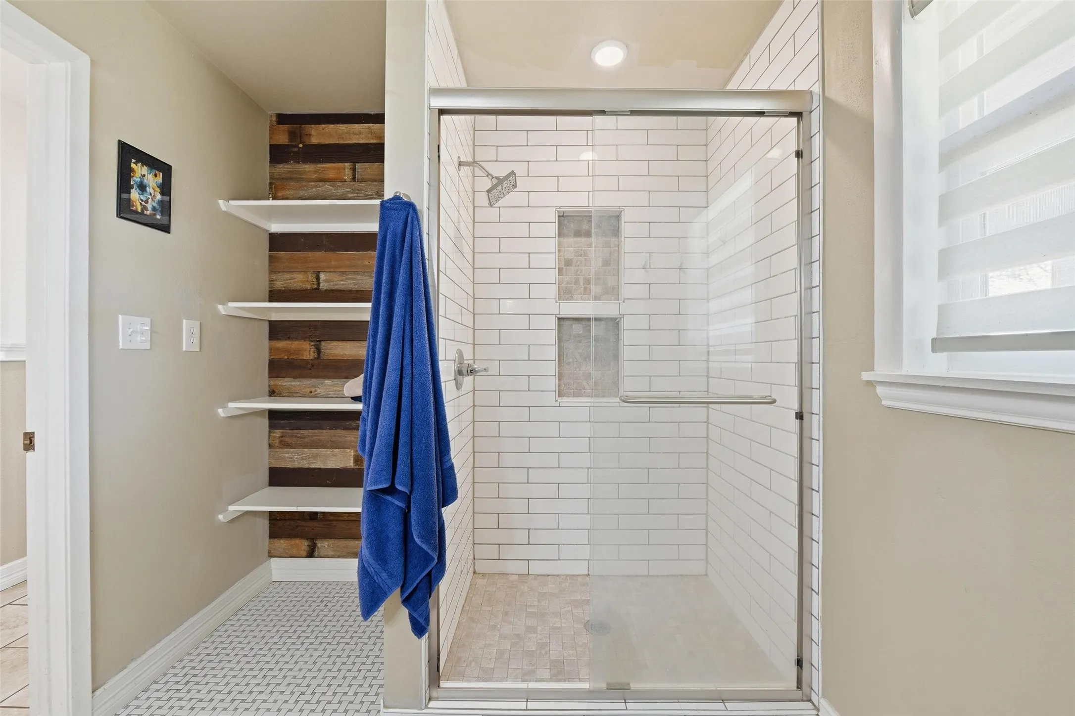 Full bathroom with a stall shower and baseboards