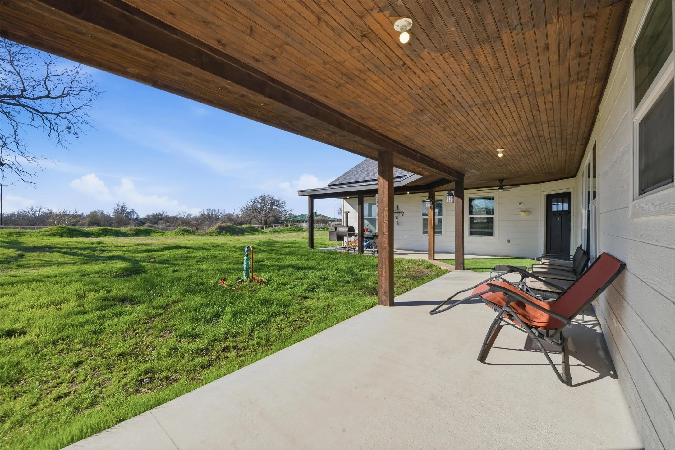 View of patio featuring a grill and ceiling fan