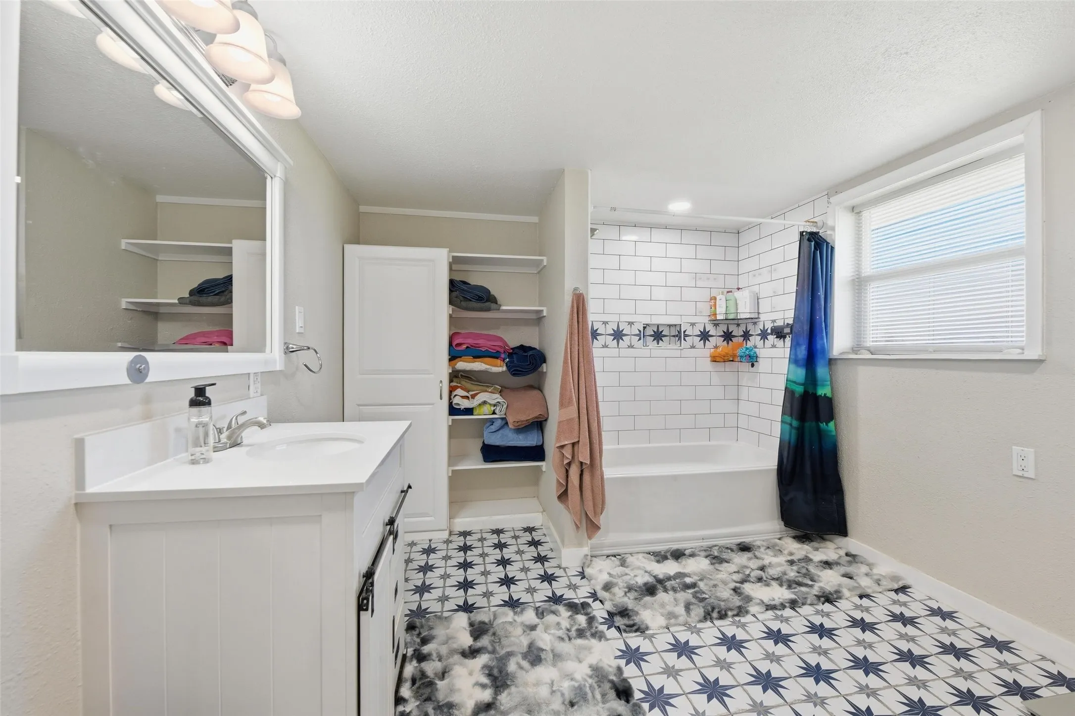 Full bathroom with vanity and shower / tub combo