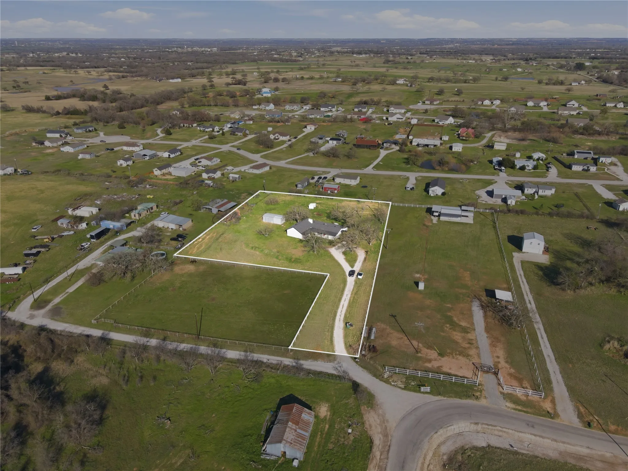 Aerial perspective showcasing a property with extensive land