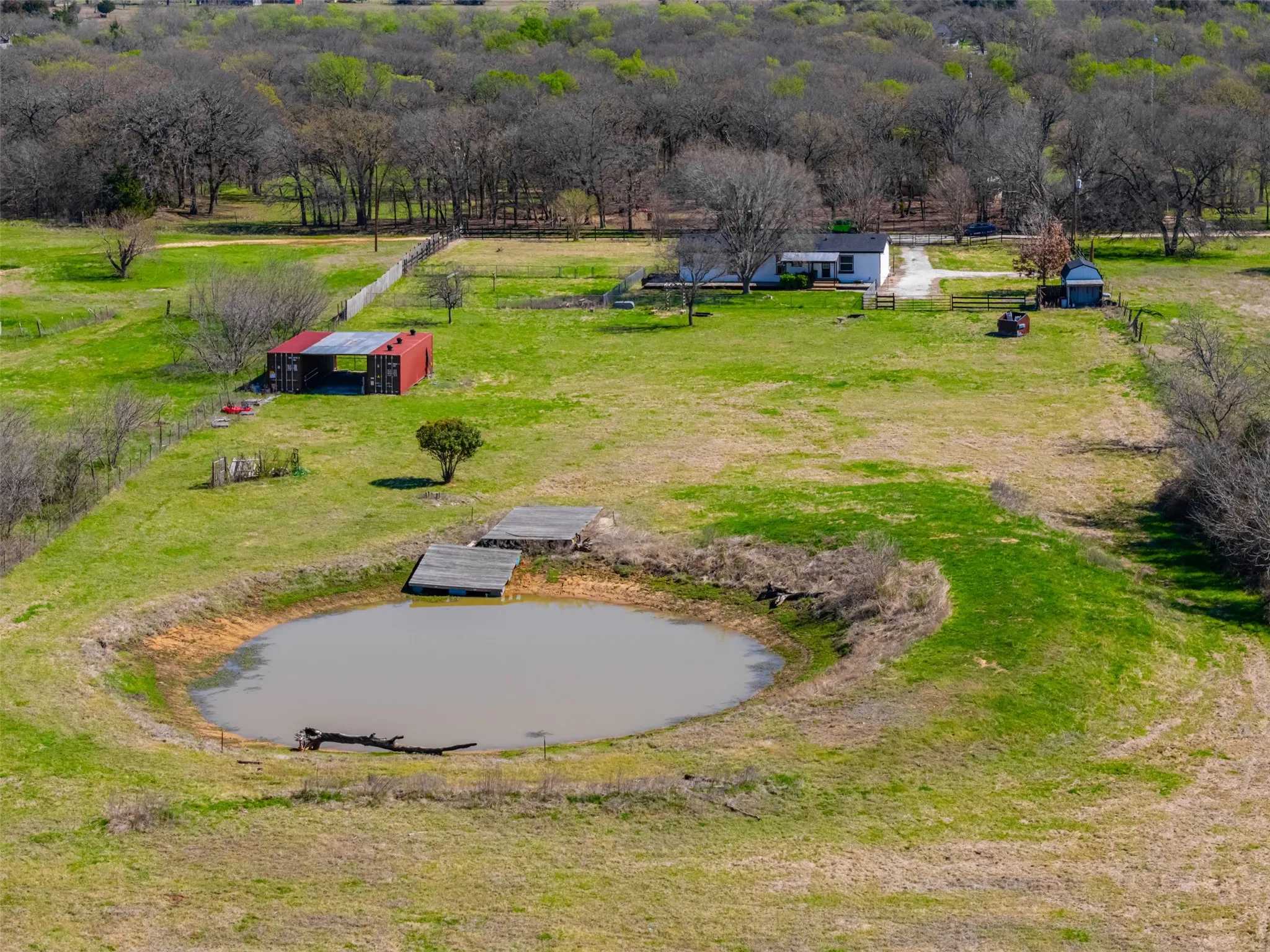 Private pond with floating dock and deck on 13 acre retreat in Whitney Texas
