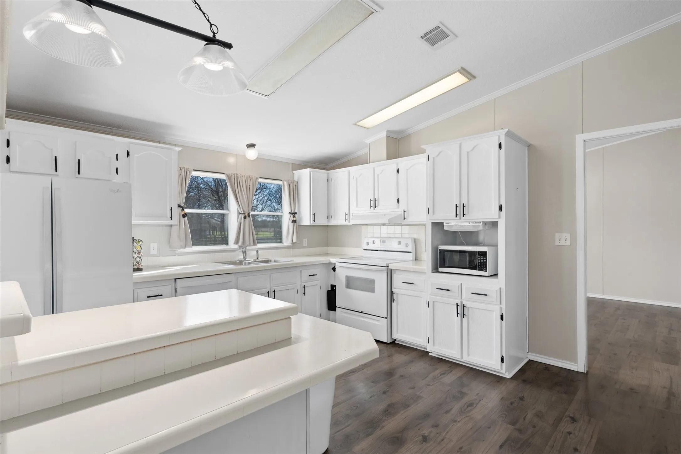 Functional kitchen with island designed for cooking and gathering in Whitney Texas