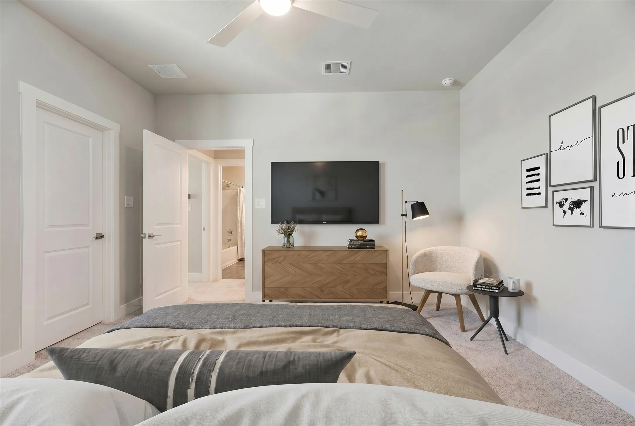 Carpeted room with light gray walls, a white ceiling fan, and white trim