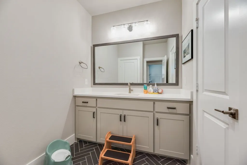 Bathroom with vanity and baseboards
