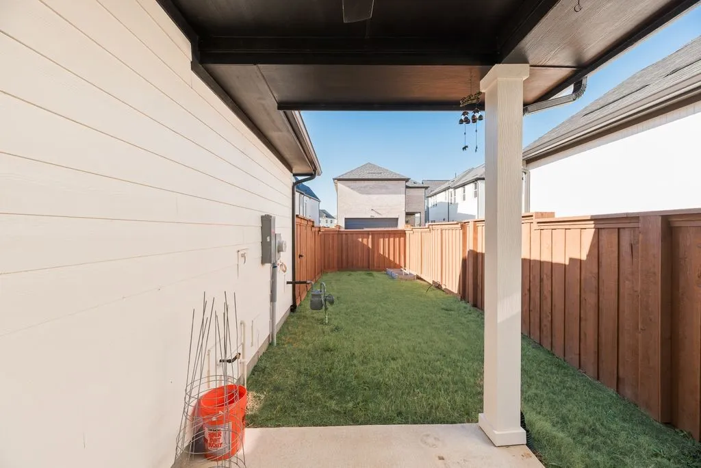Fenced backyard with a patio area
