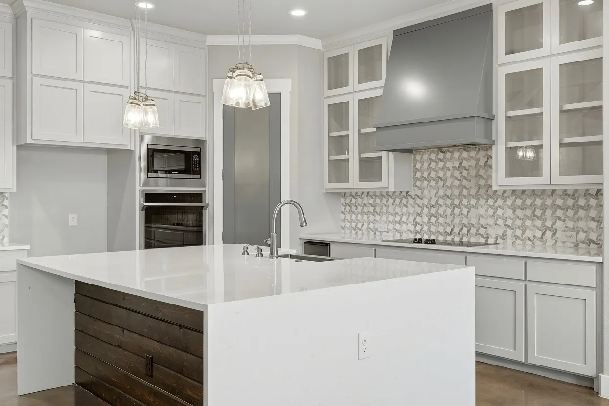 Kitchen featuring a large island with a wood-finish base, integrated sink, and pendant lighting