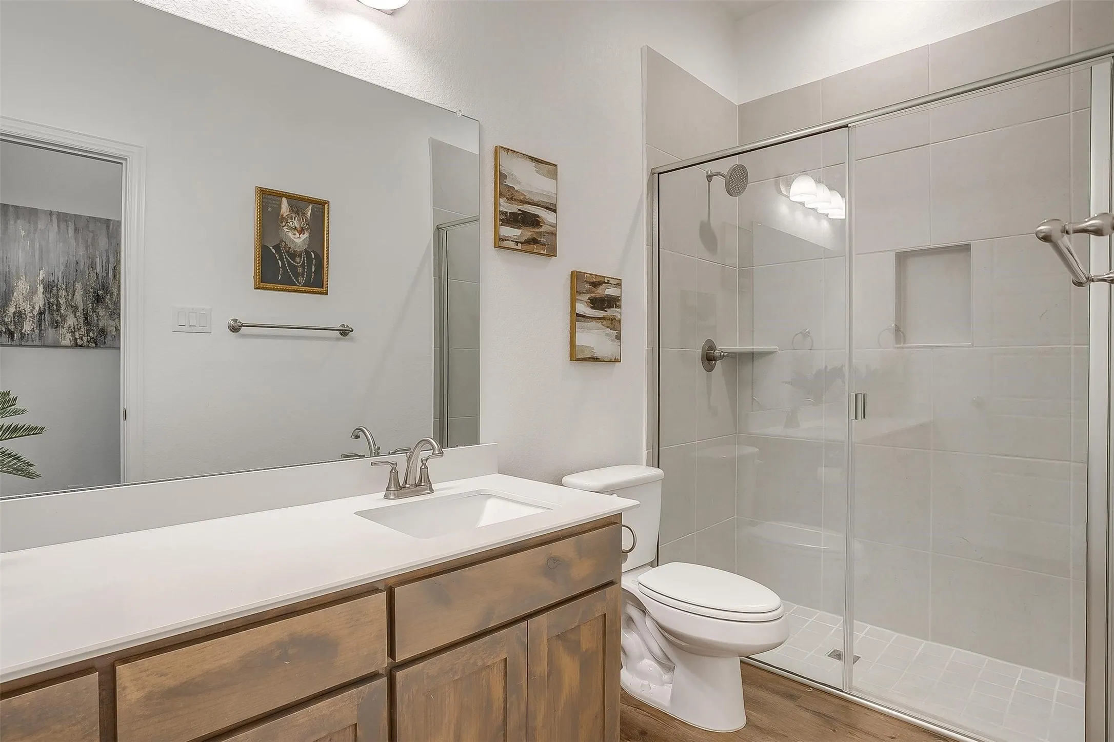 Guest room bath with walk-in shower, chrome fixtures, rain-style shower head, plenty of under counter space and excellent lighting.