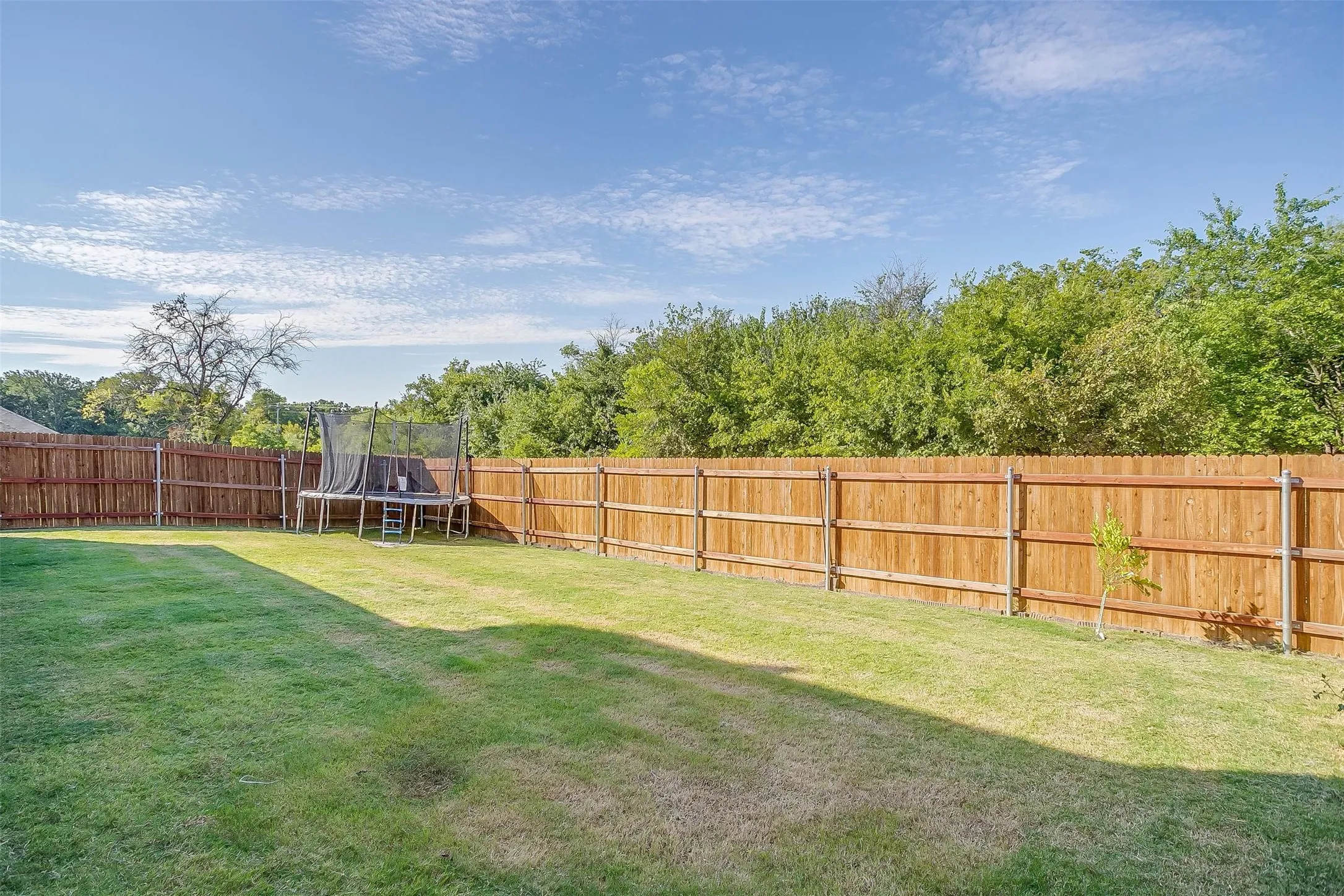 Back yard has plenty of space for your landscaping or gardening ideas or play equipment!  And look at the view of the trees!