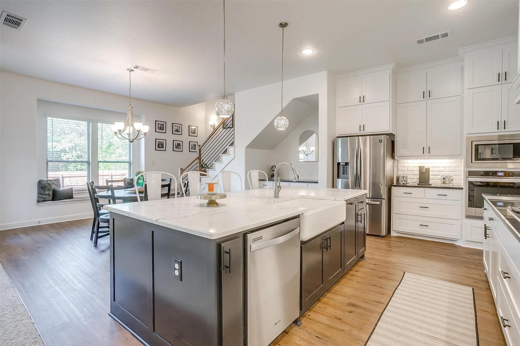 View of entire kitchen and dining area -- there's an abundance of drawers --lateral, too! -- and cabinets.  Easy care flooring, elegant countertops and all the kitchen perfection you need!