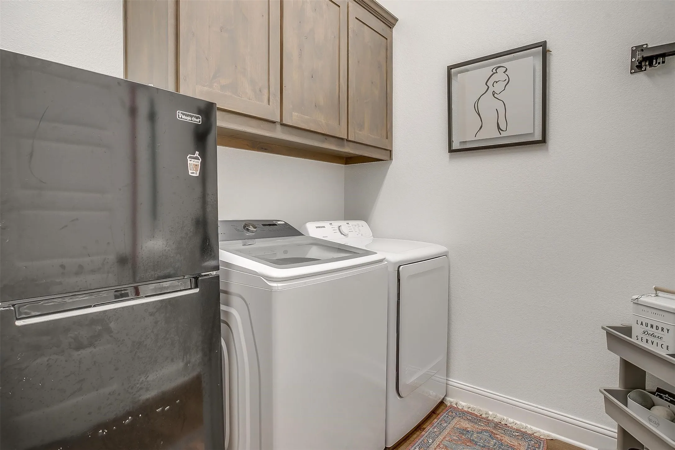 Utility room is complete with room for full-sized washer and dryer, plus  cabinets above your laundry supplies -- AND room for a full-sized refrigerator!