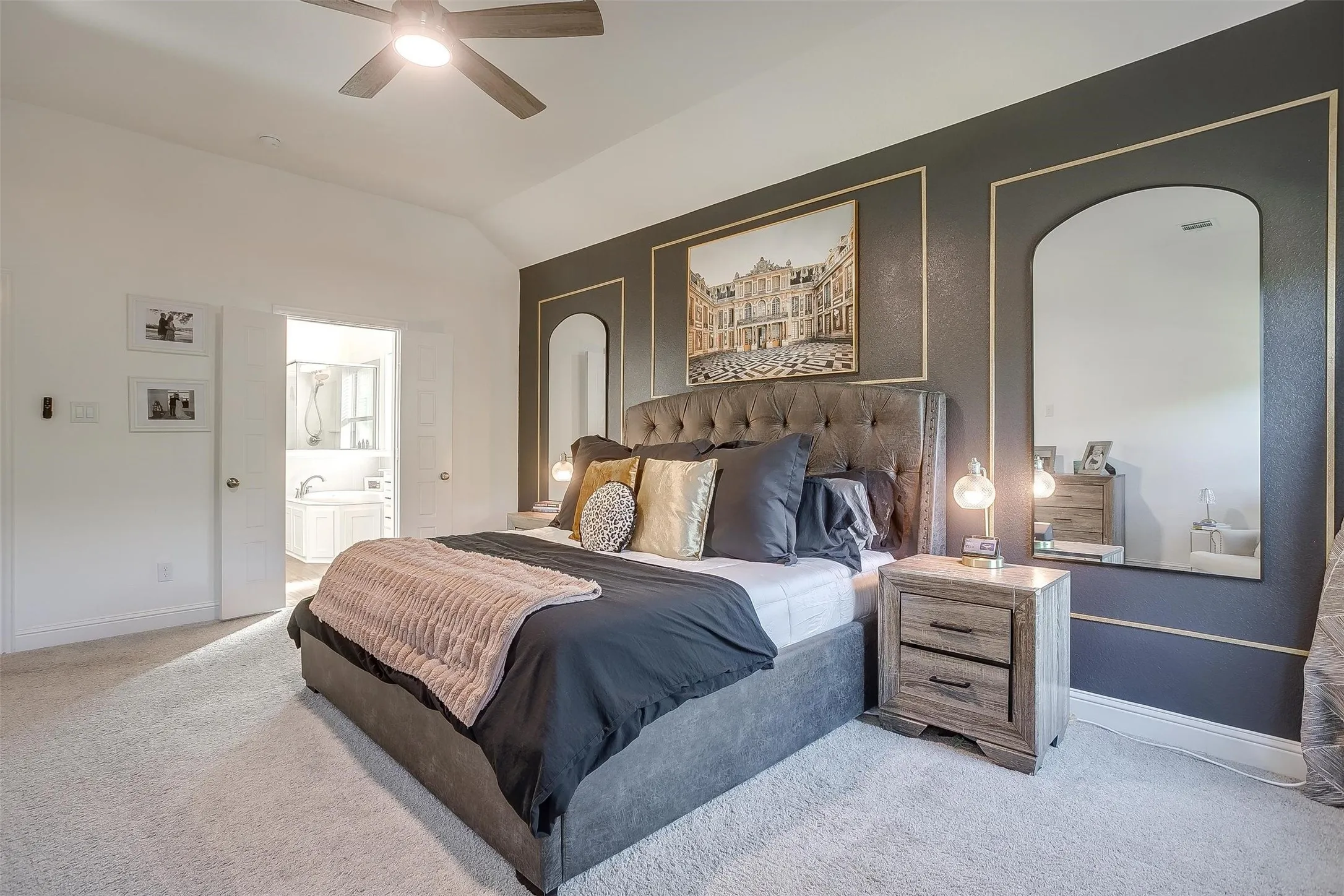View in primary bedroom to ensuite primary bath beyond -- generous amount of space plus the convenience of the bath and walk-in closet adjacent.