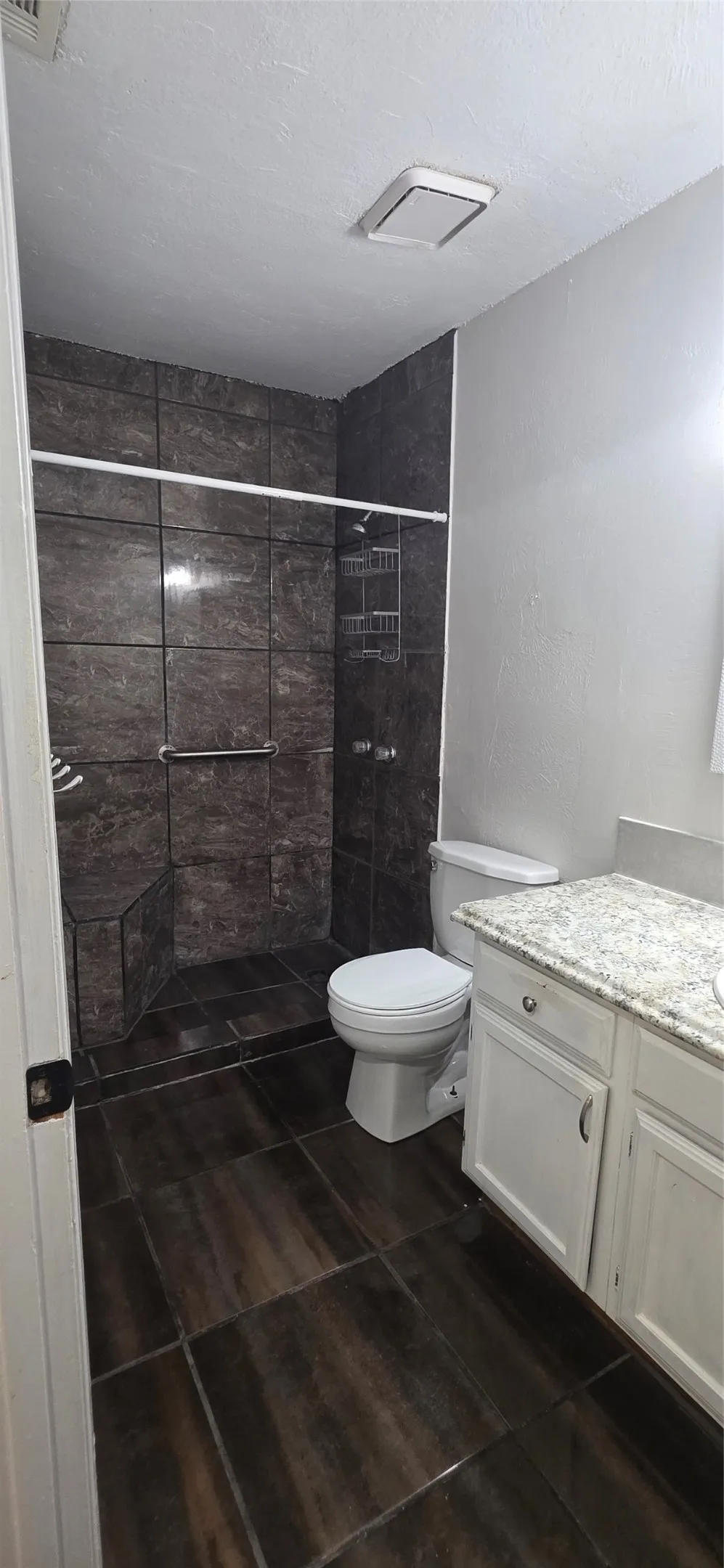 Full bathroom featuring vanity and a shower stall