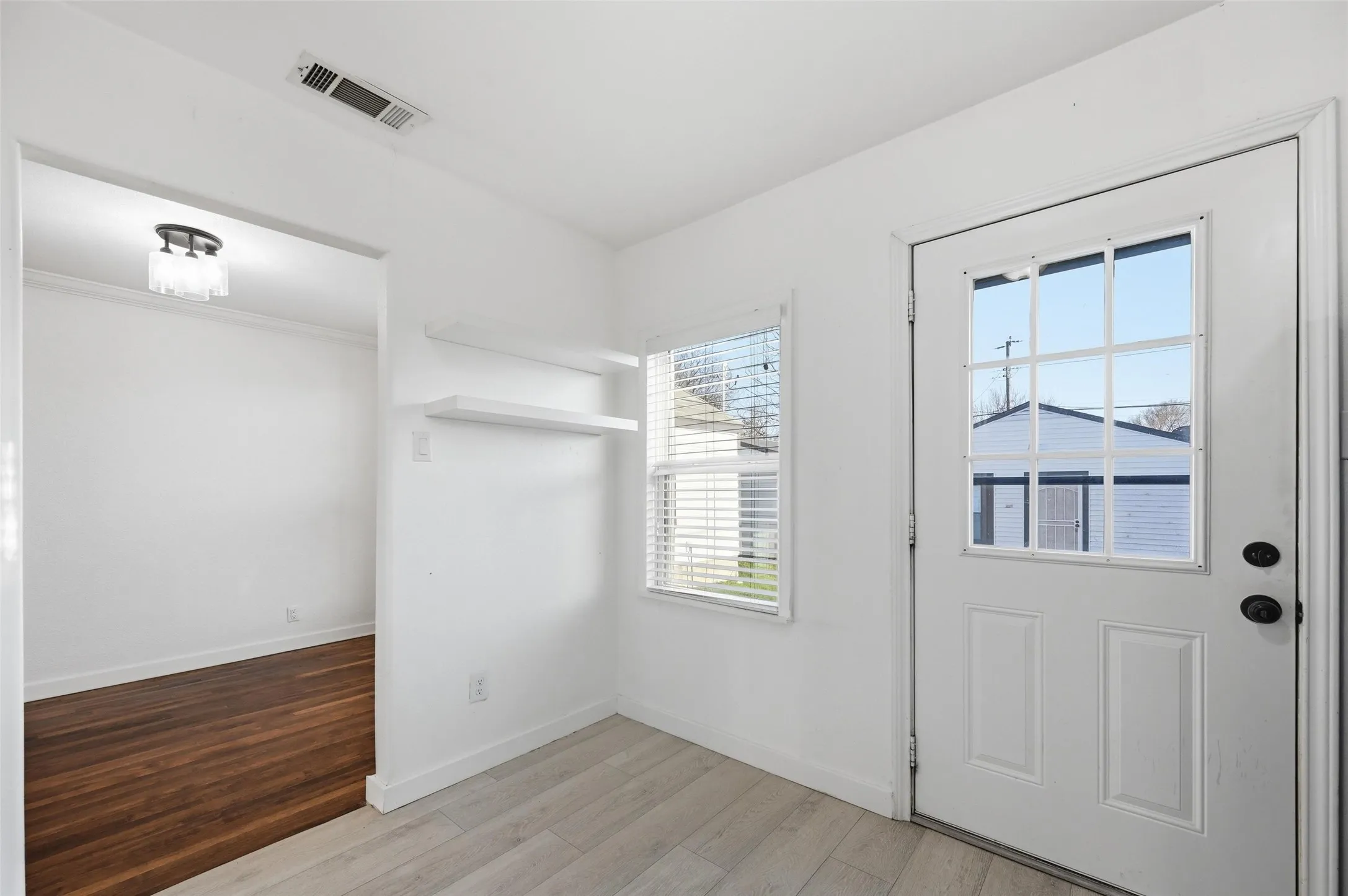 Doorway to outside featuring wood finished floors and baseboards