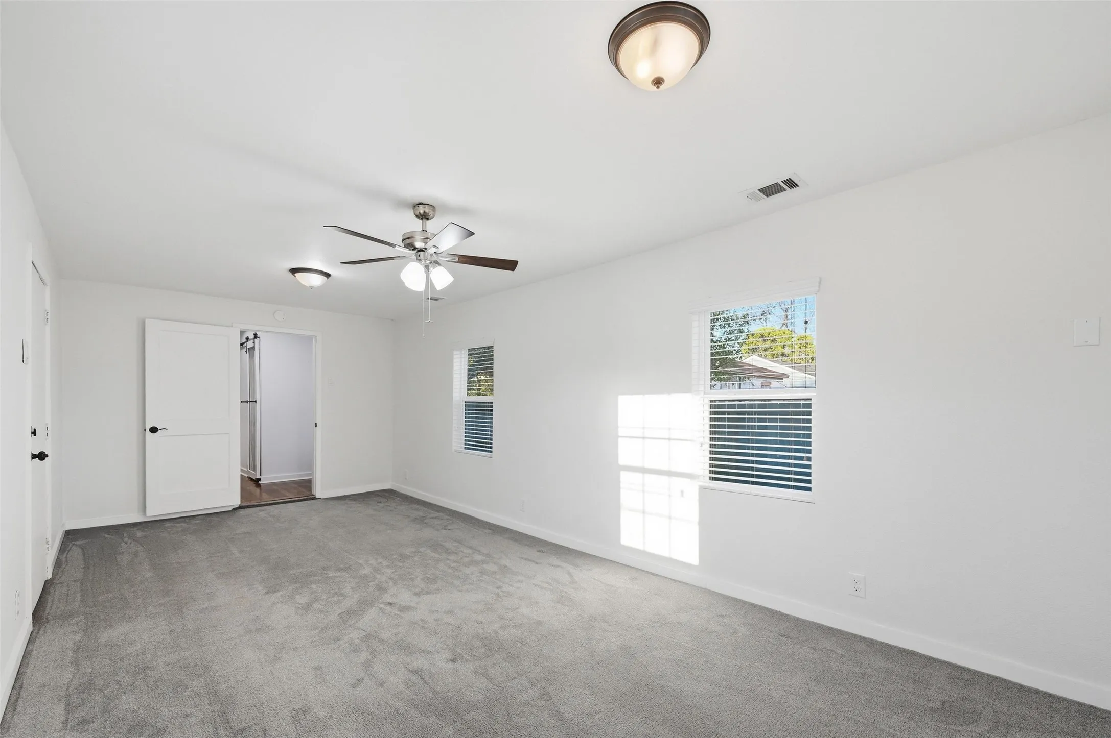 Unfurnished bedroom with carpet and a ceiling fan