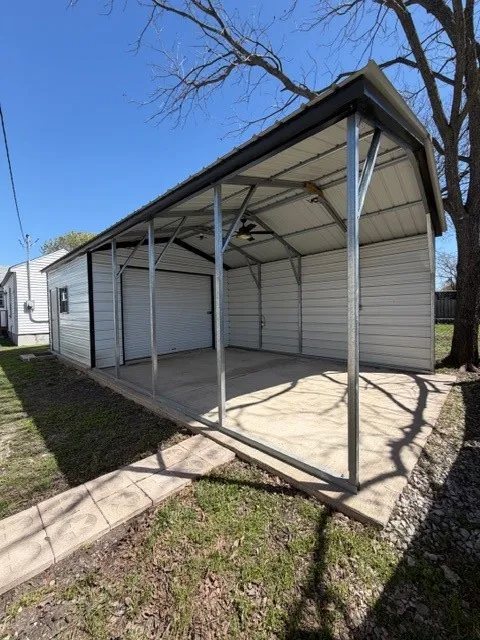 View of parking featuring a carport