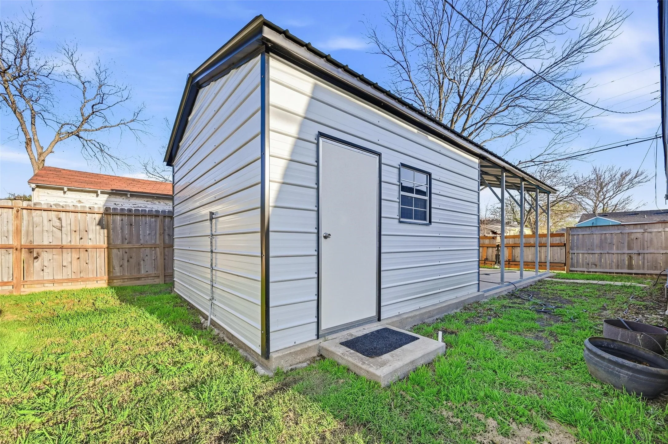 View of shed with a fenced backyard