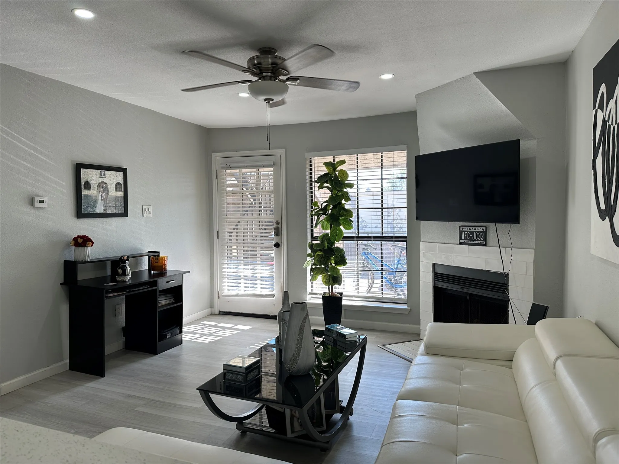 Living area with a fireplace, ceiling fan