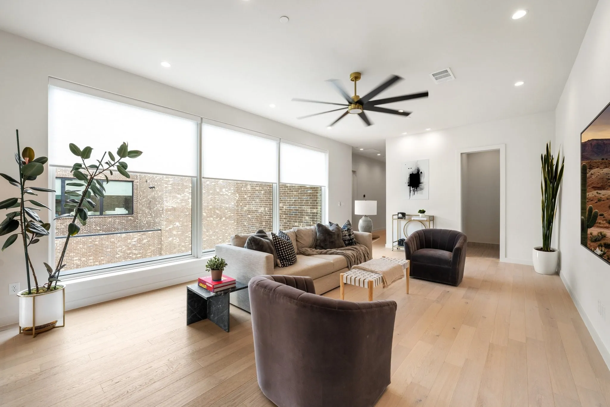 Second Living room with light wood finished floors, a ceiling fan, and large windows