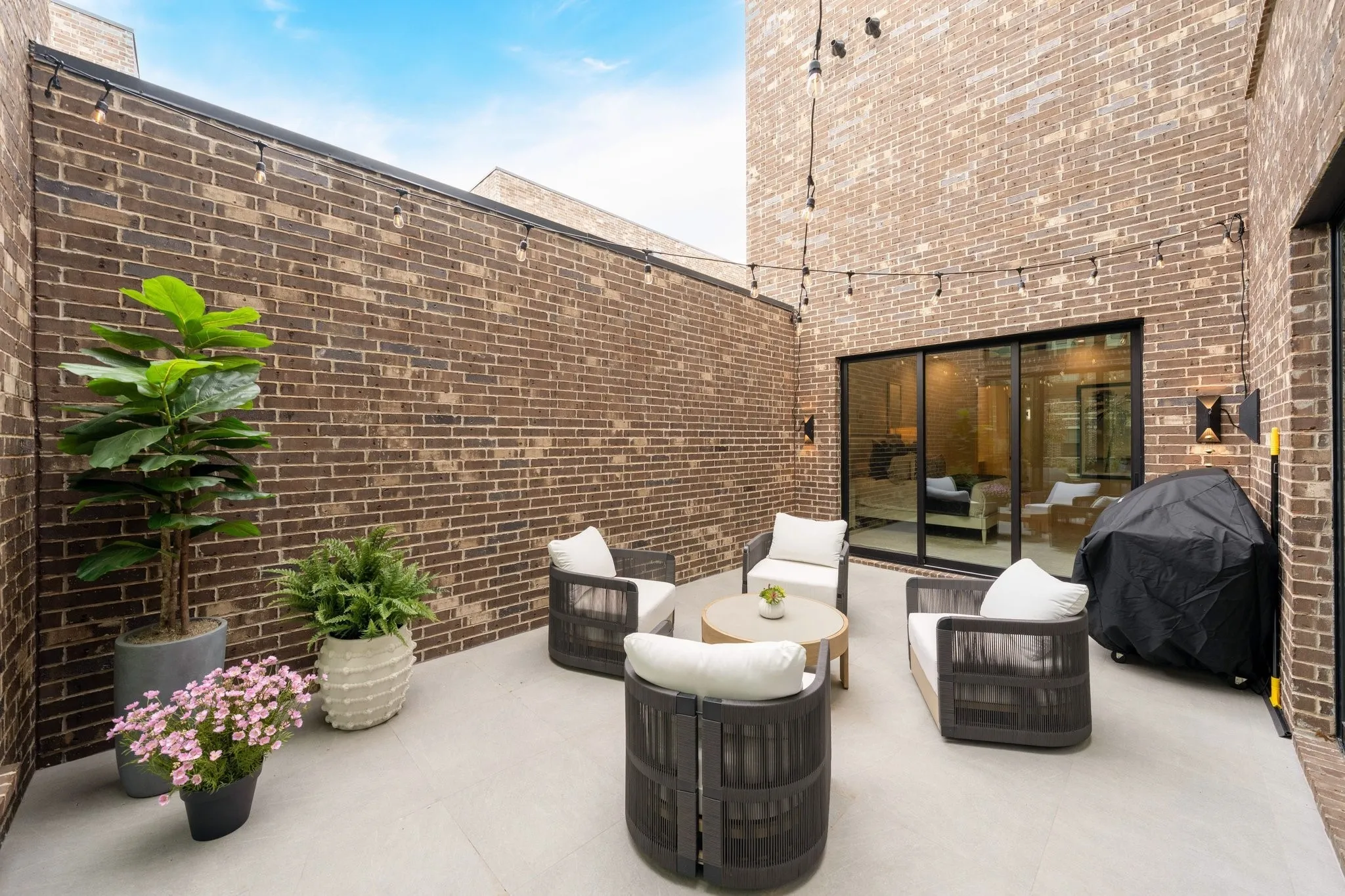 Courtyard featuring outdoor lounge area and a grill