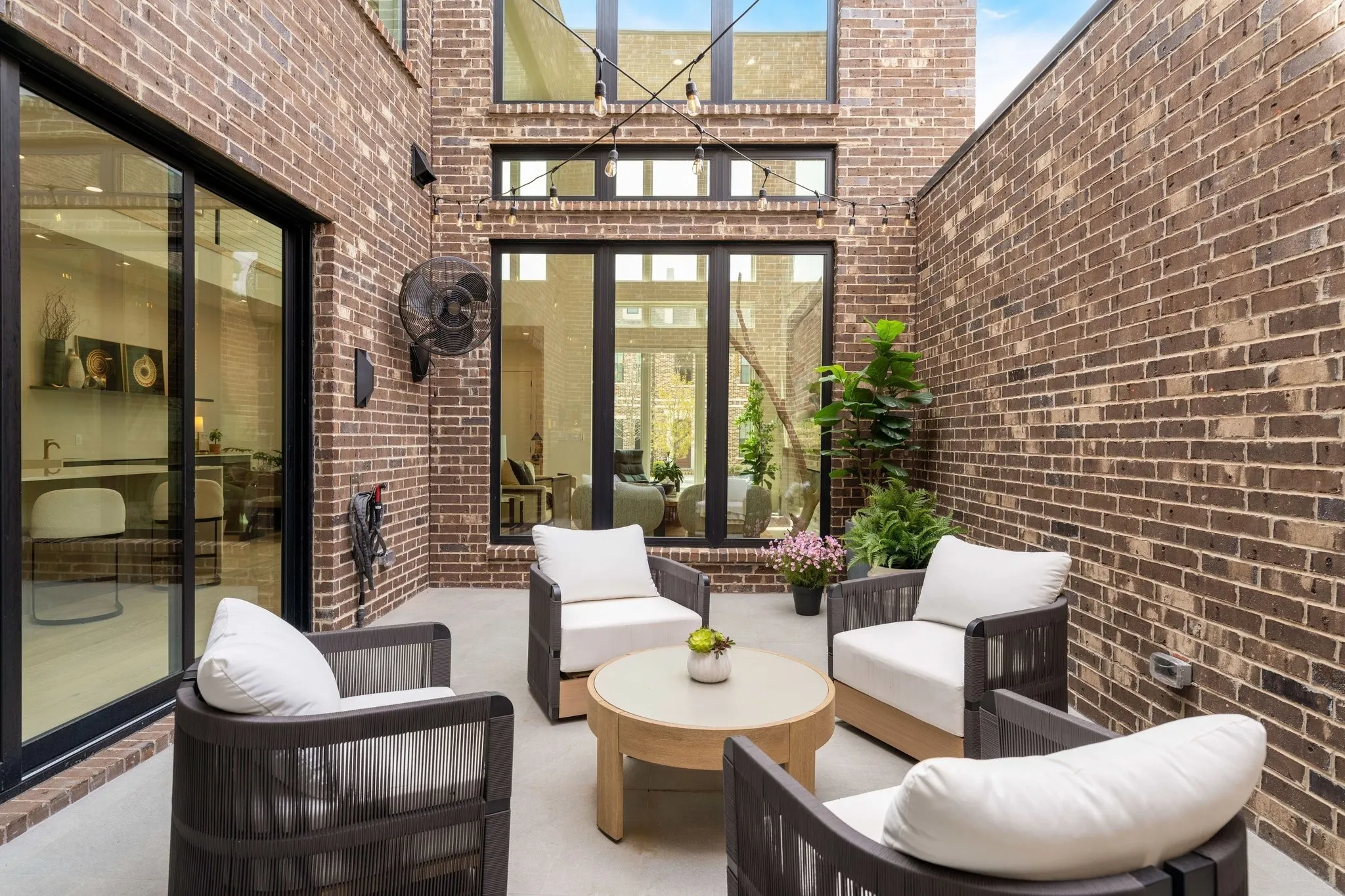 Courtyard terrace with outdoor seating Fan and large windows to inside