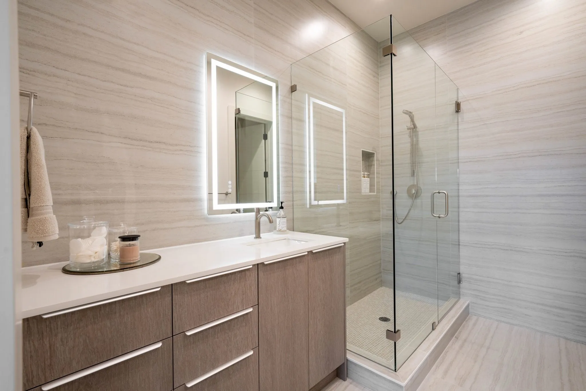 Full Ensuite bath with modern lighted vanity and a stall shower