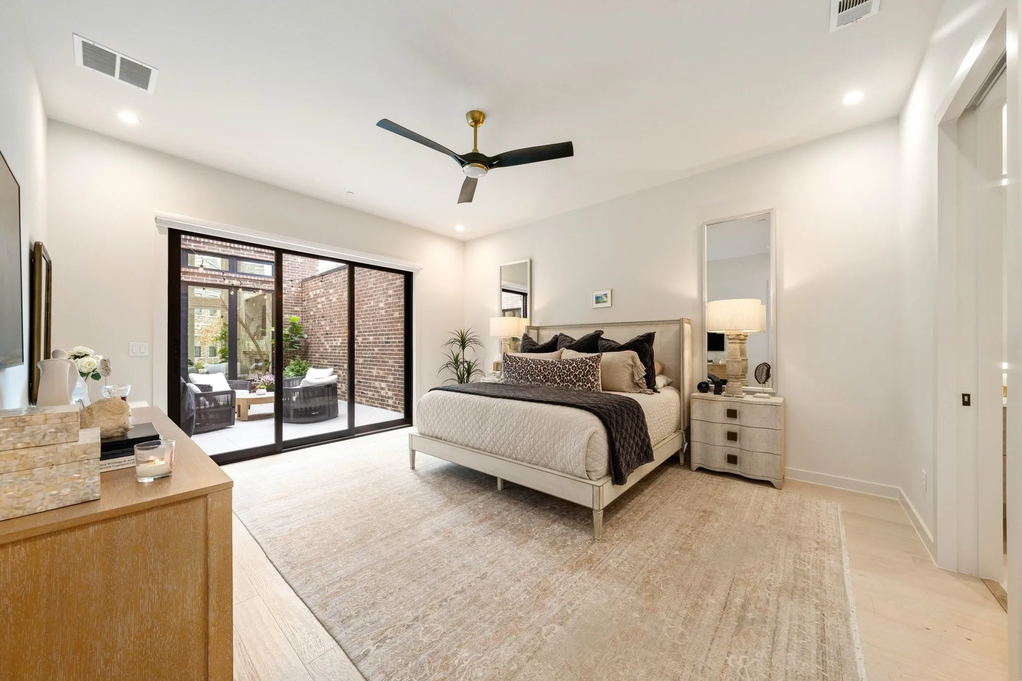 Bedroom featuring slider access to courtyard,  large enough for vanity and dresser