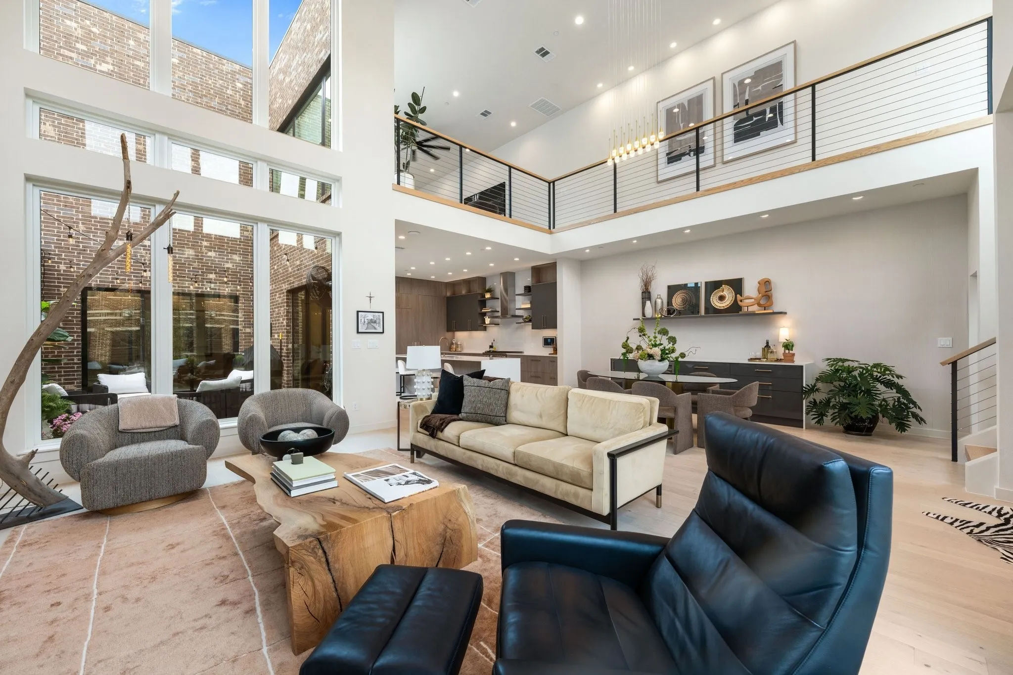 Open concept kitchen /living area featuring a high ceiling, open to second living and recessed lighting