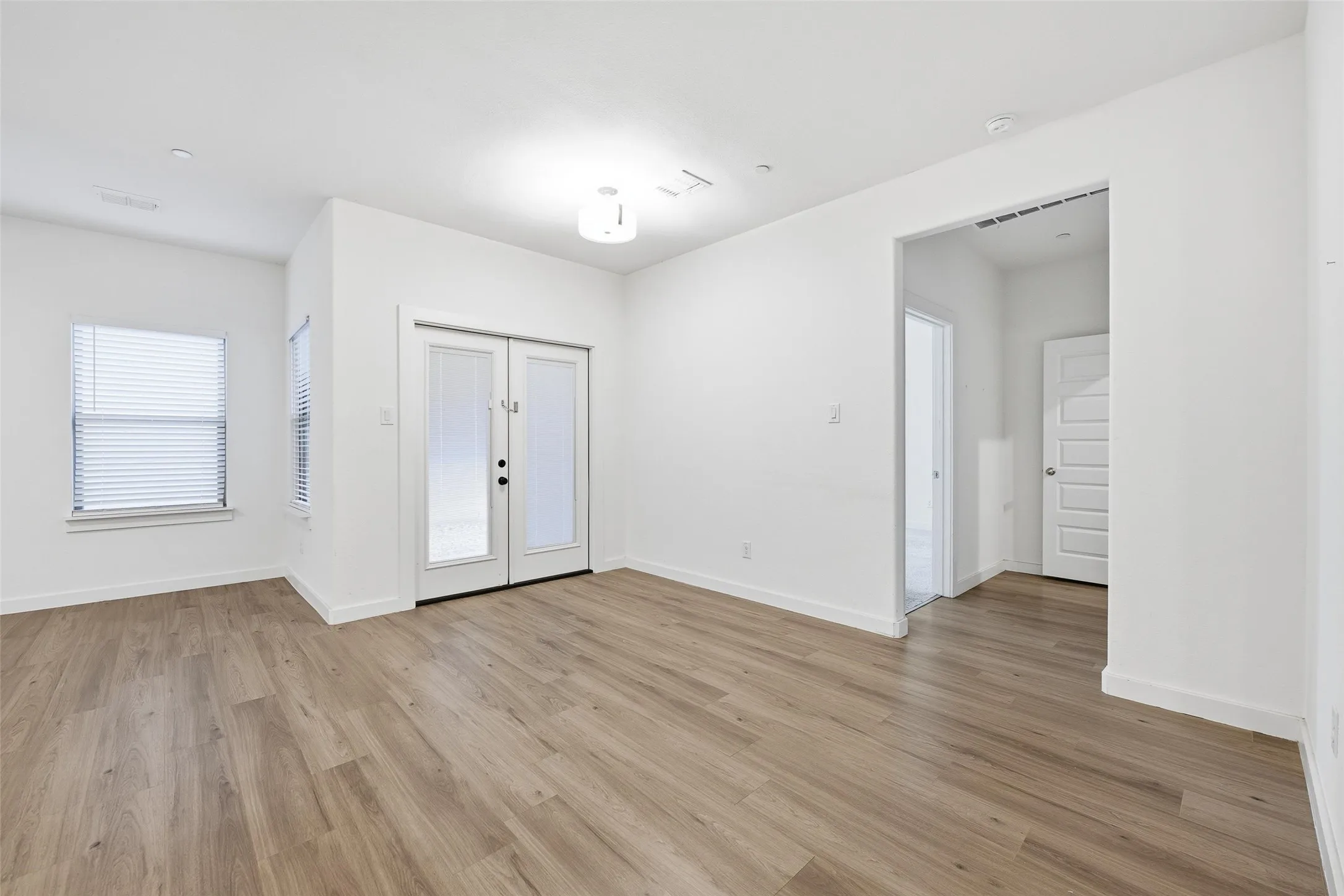 Foyer entrance featuring light wood-style flooring and french doors