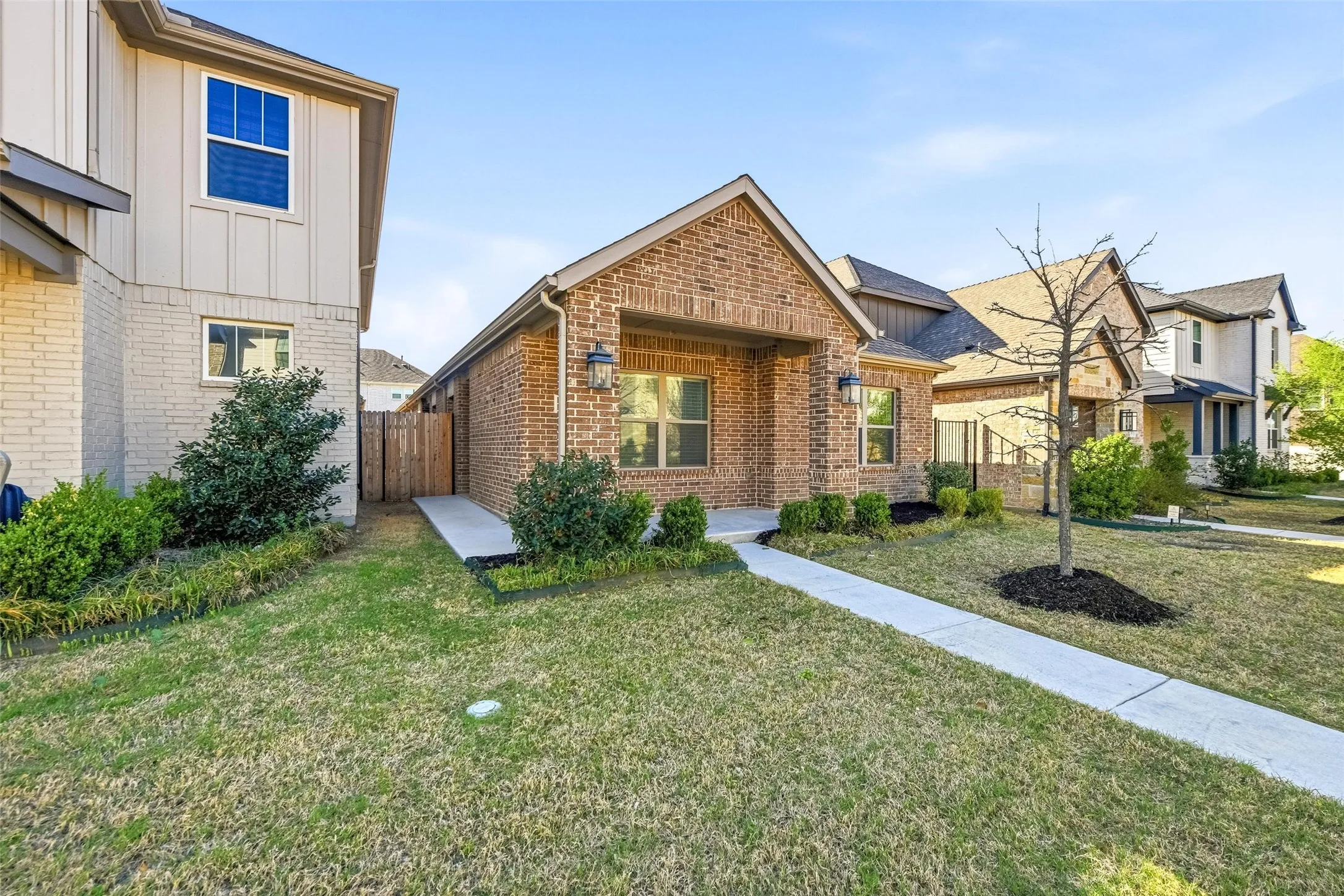 View of front of property featuring board and batten siding and brick siding