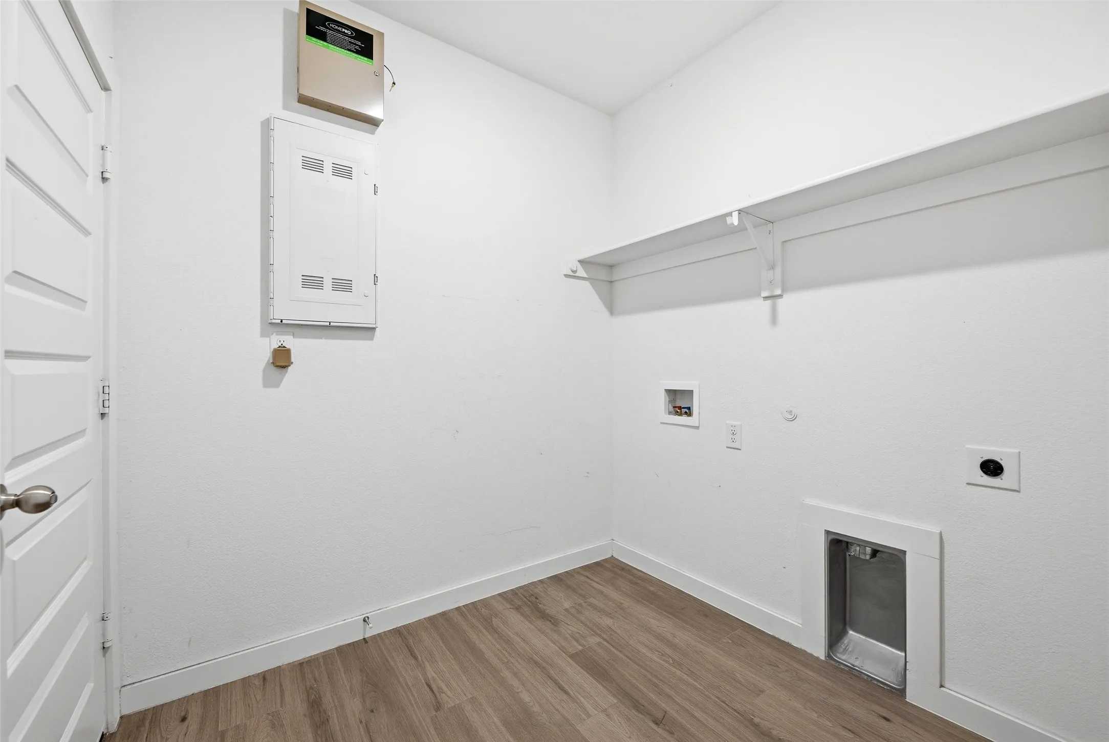 Laundry room featuring hookup for a gas dryer, light wood finished floors, electric dryer hookup, and hookup for a washing machine