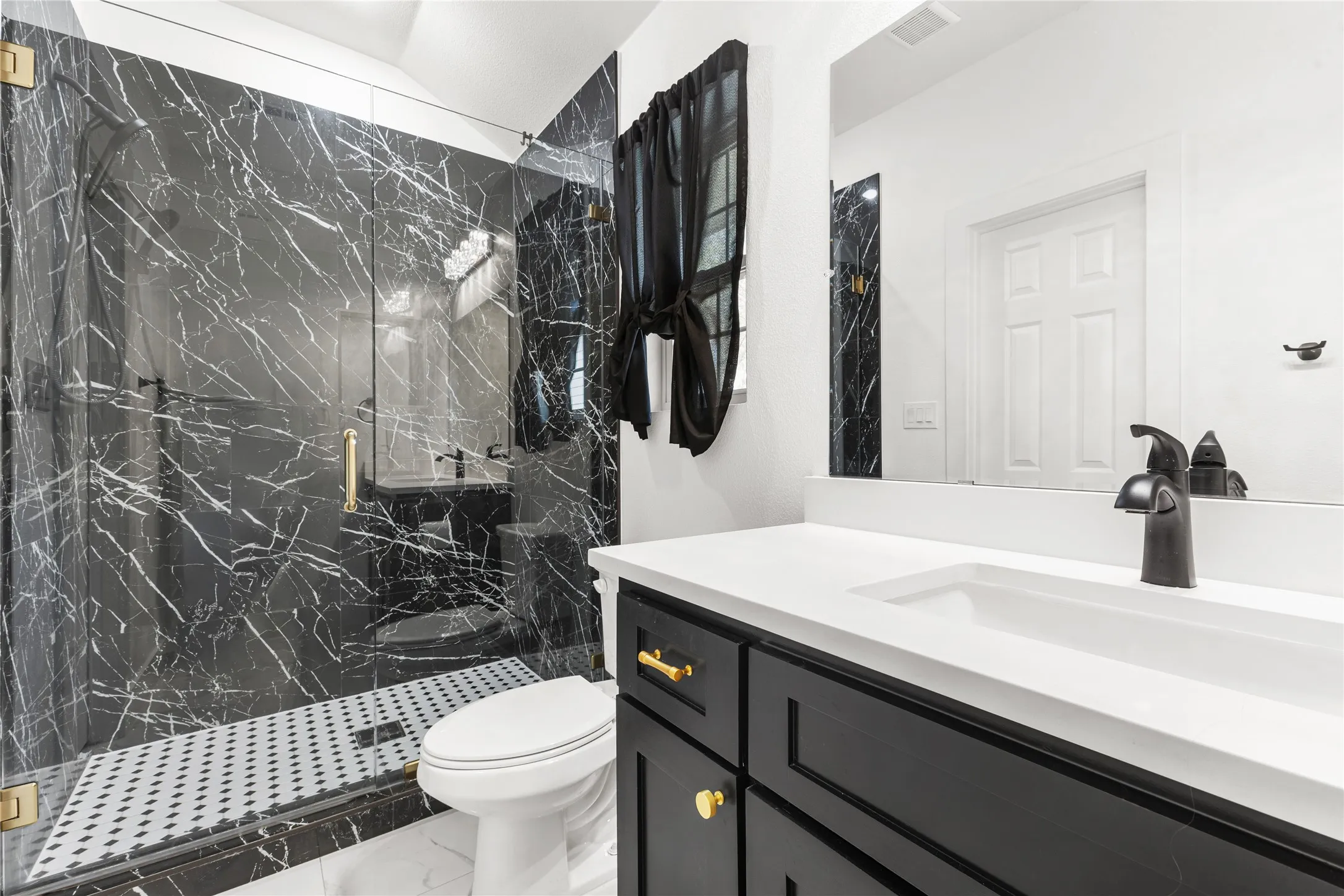 Bathroom with vanity, a marble finish shower, and light marble finish flooring