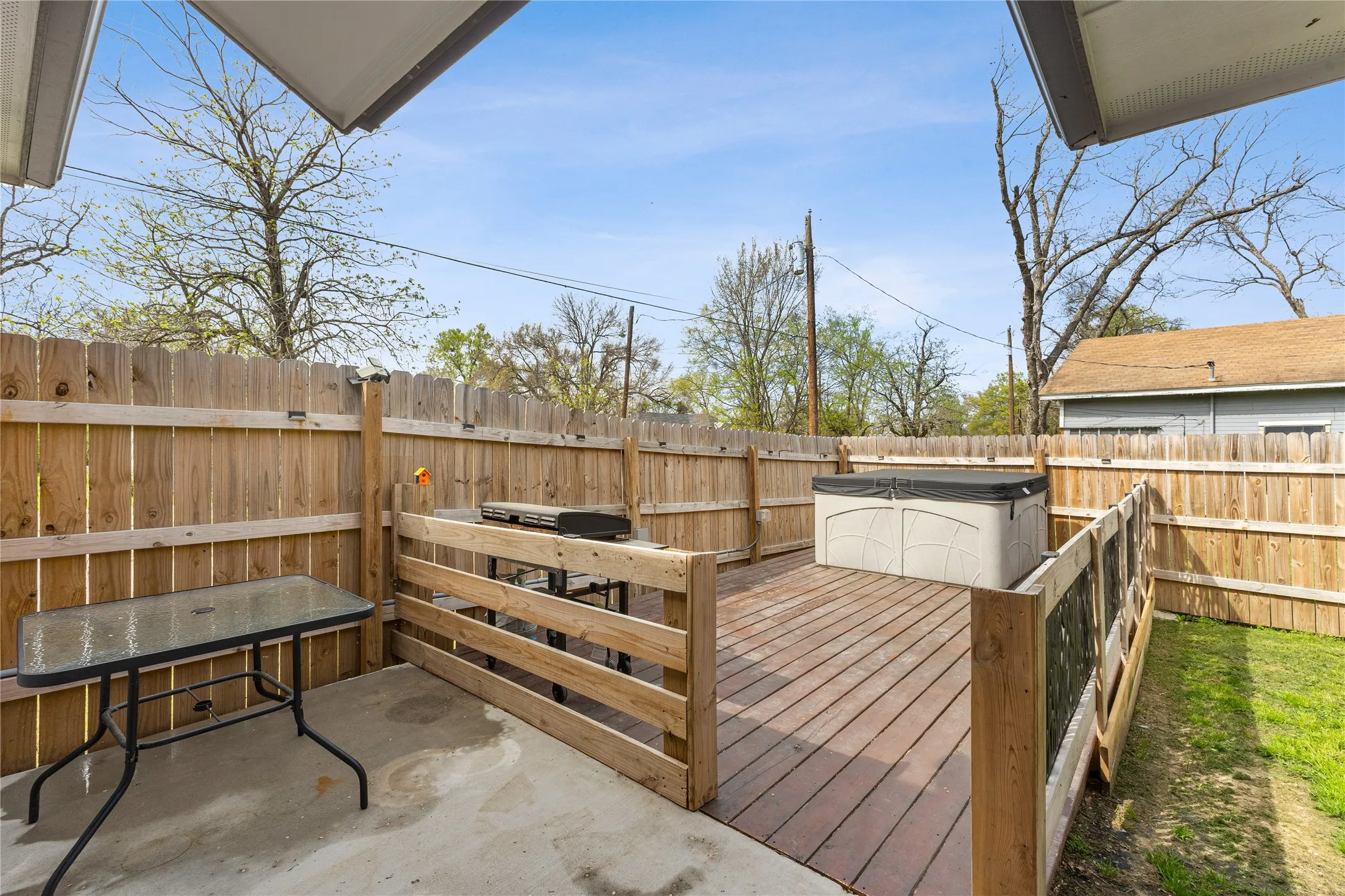Wooden deck with a fenced backyard