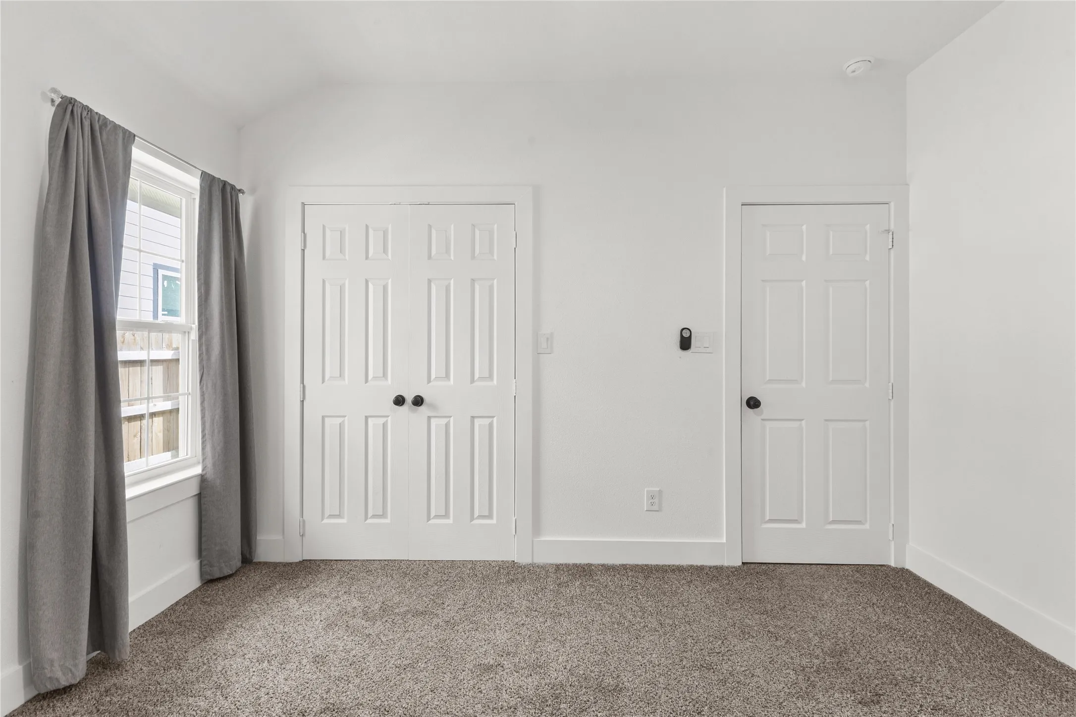 Unfurnished bedroom with a closet, carpet floors, and lofted ceiling