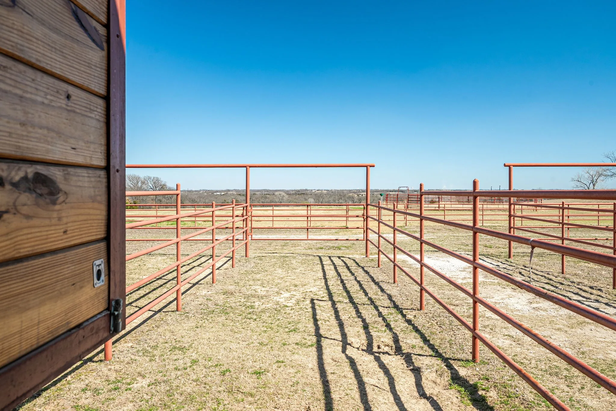 View of yard with a view of rural / pastoral area, an exterior structure, and an outbuilding