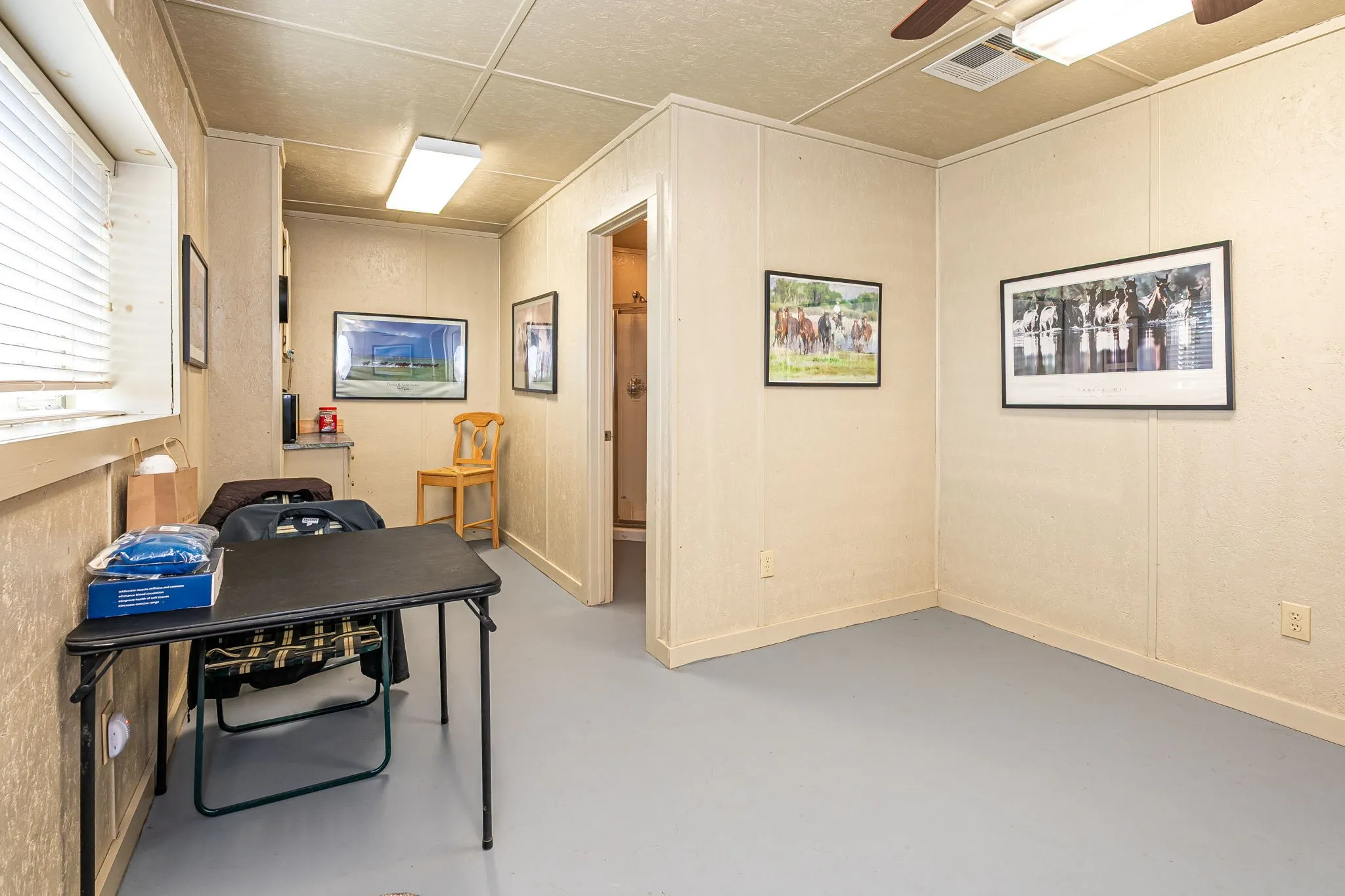 Office area featuring concrete floors and ceiling fan
